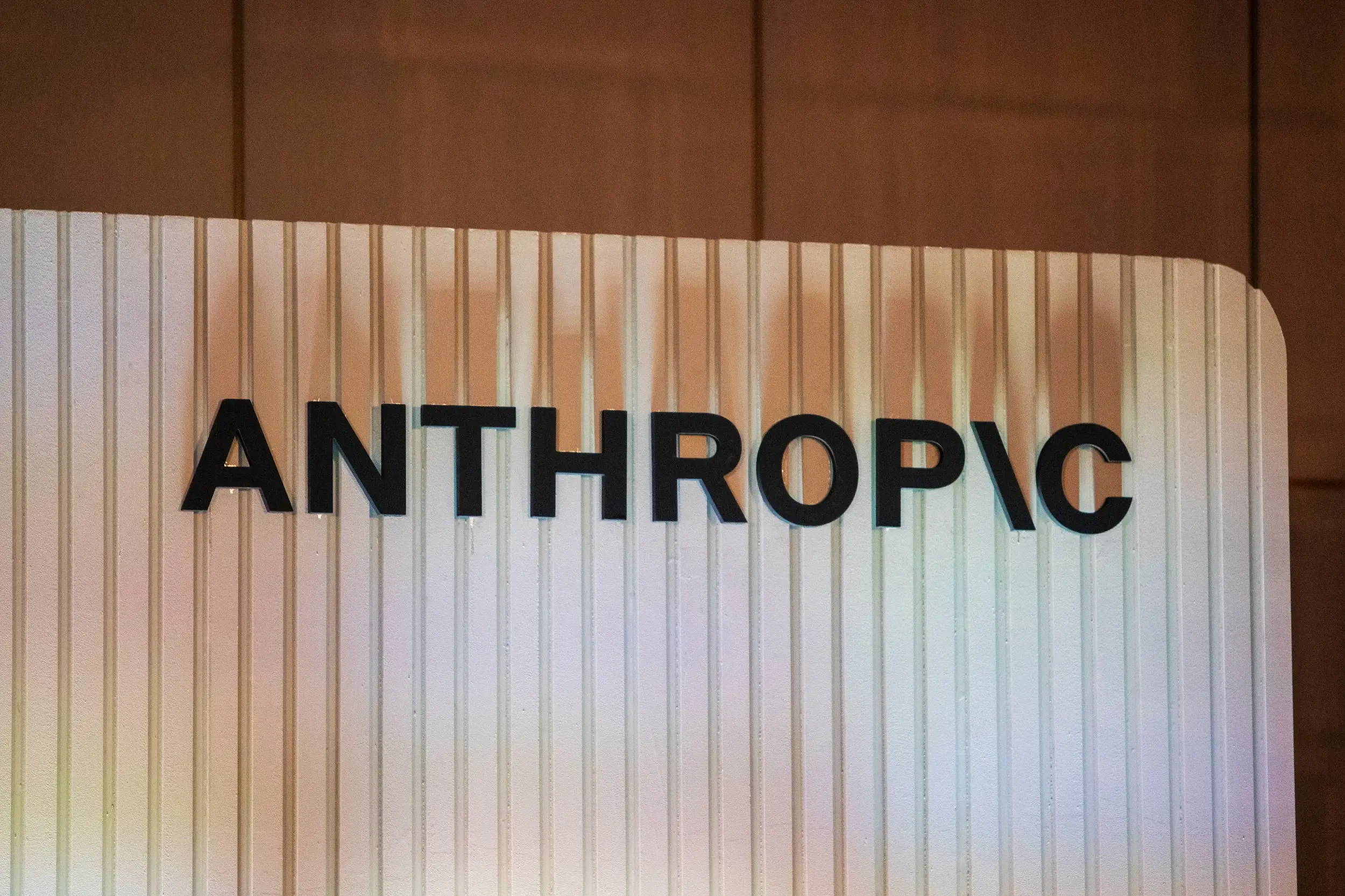 The Anthropic logo is seen on a backdrop