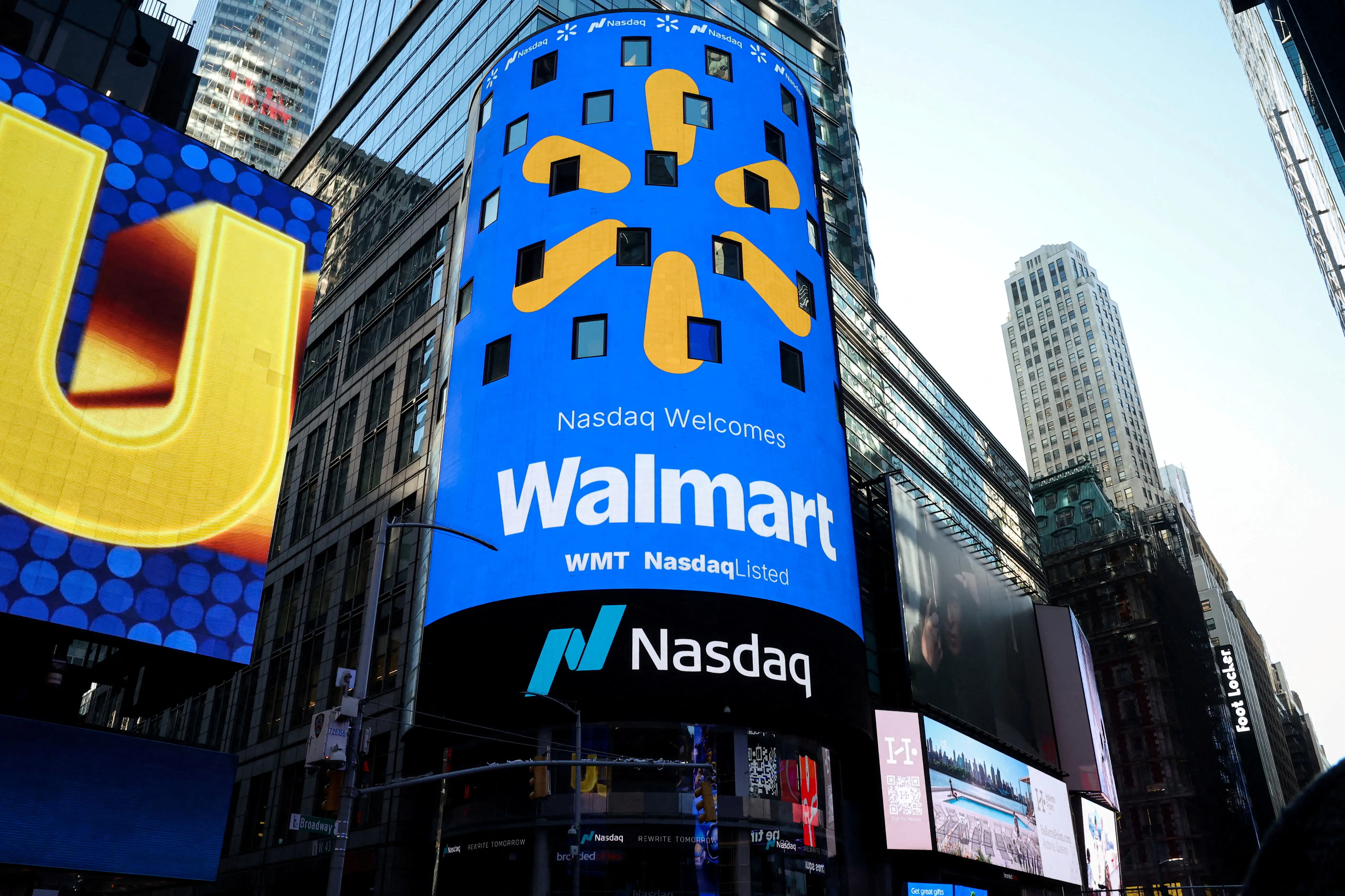 A screen displays the Walmart logo during the opening bell ceremony at the Nasdaq Market to celebrate the company's listing transfer, in New York City, December 9, 2025.