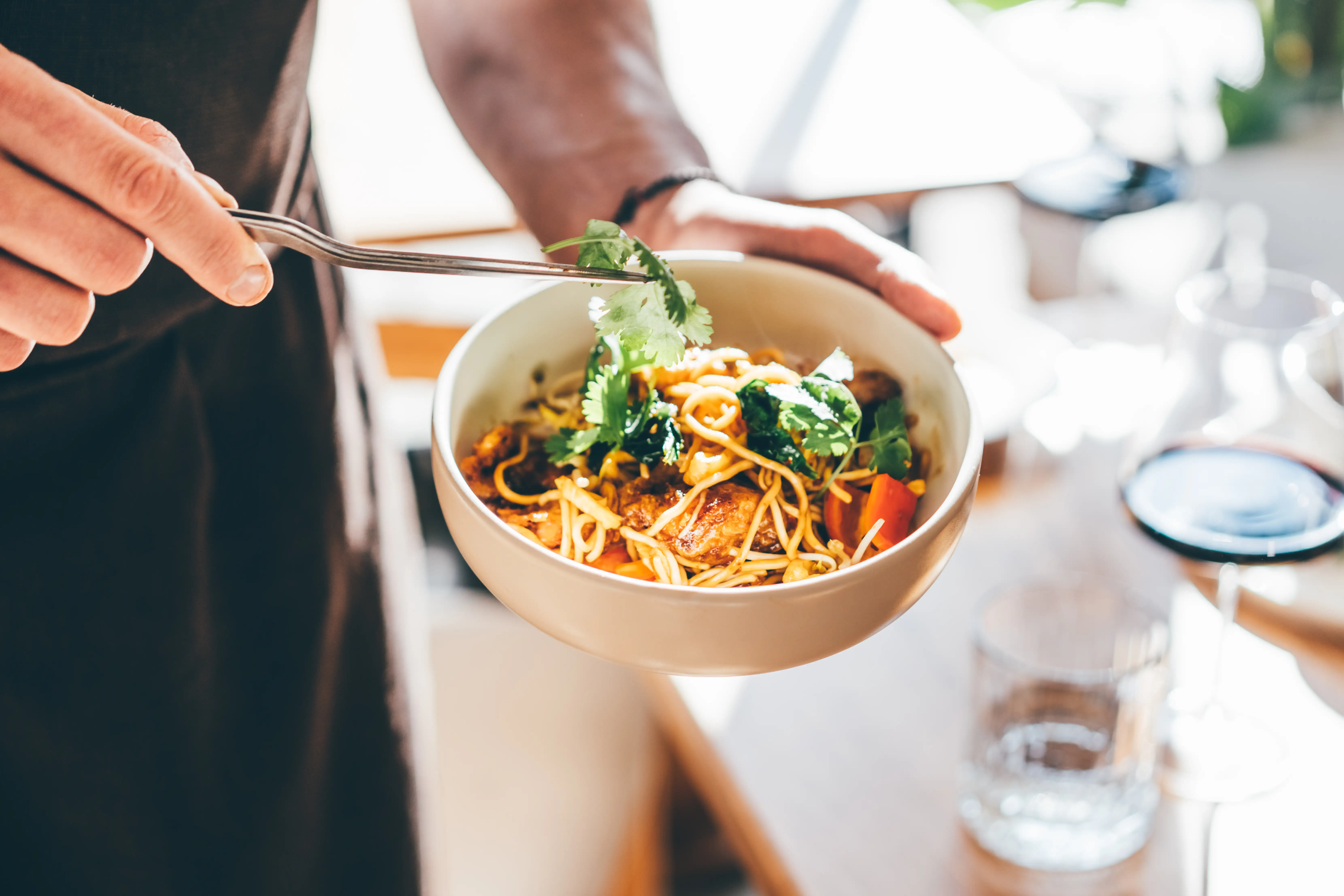 A bowl of noodles with chicken.