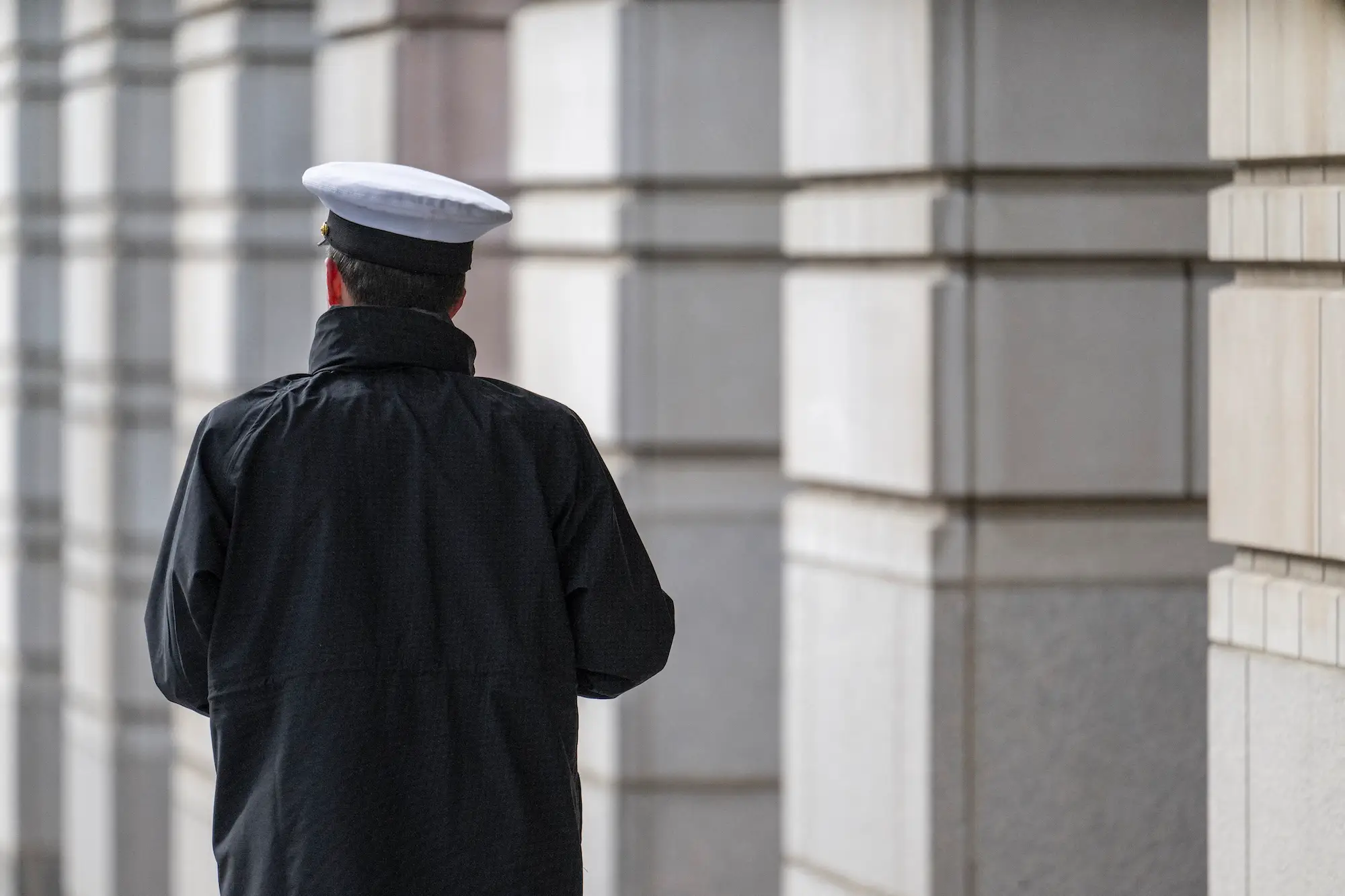 A member of the US military outside a Washington, D.C., courthouse, where a February 2025 hearing was held over transgender troops' lawsuit seeking to block their separation.