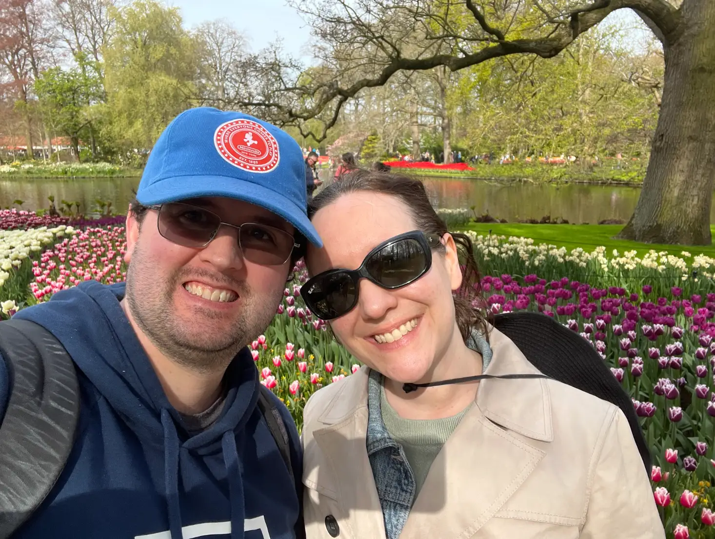 The writer and her partner standing in front of tulips on a Netherlands trip.