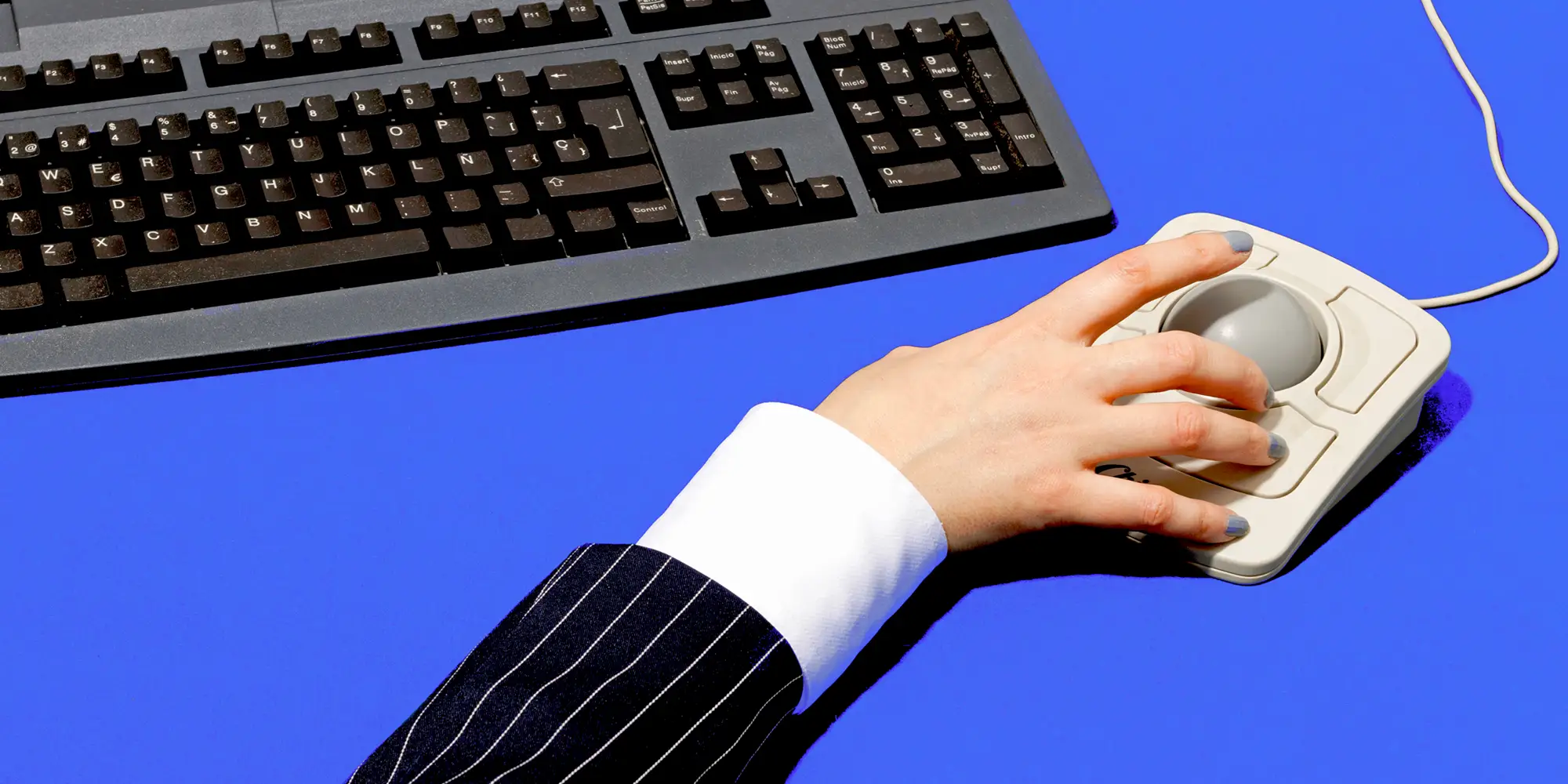 A hand at a computer