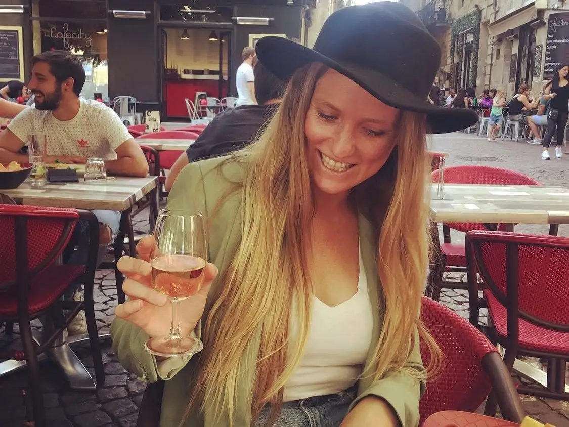 Woman smiling with glass of wine