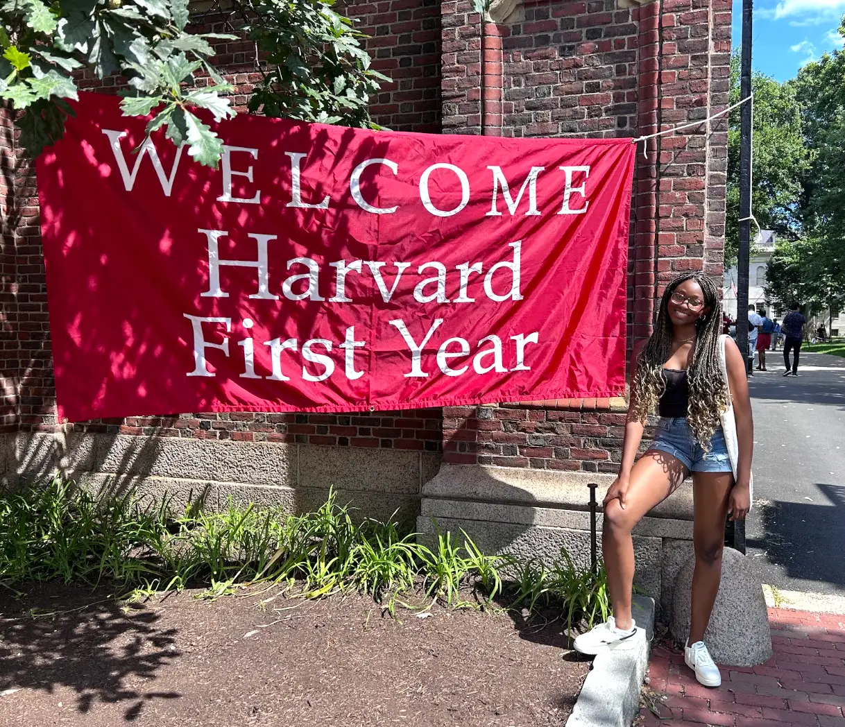 Jasmine Wynn in front fo a sign that reads 