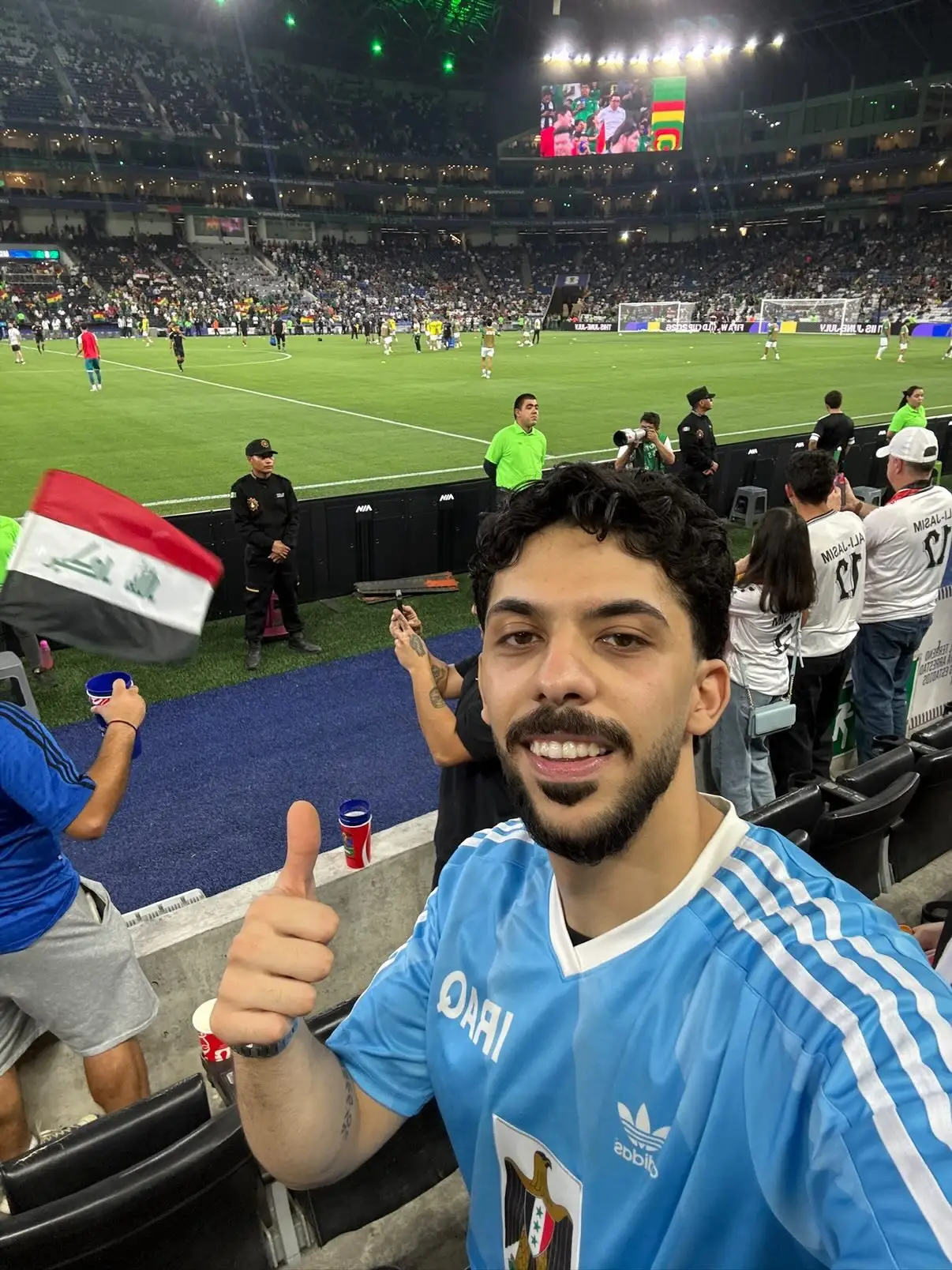 Mo Faraj does a thumbs-up in front of a football pitch in Mexico.