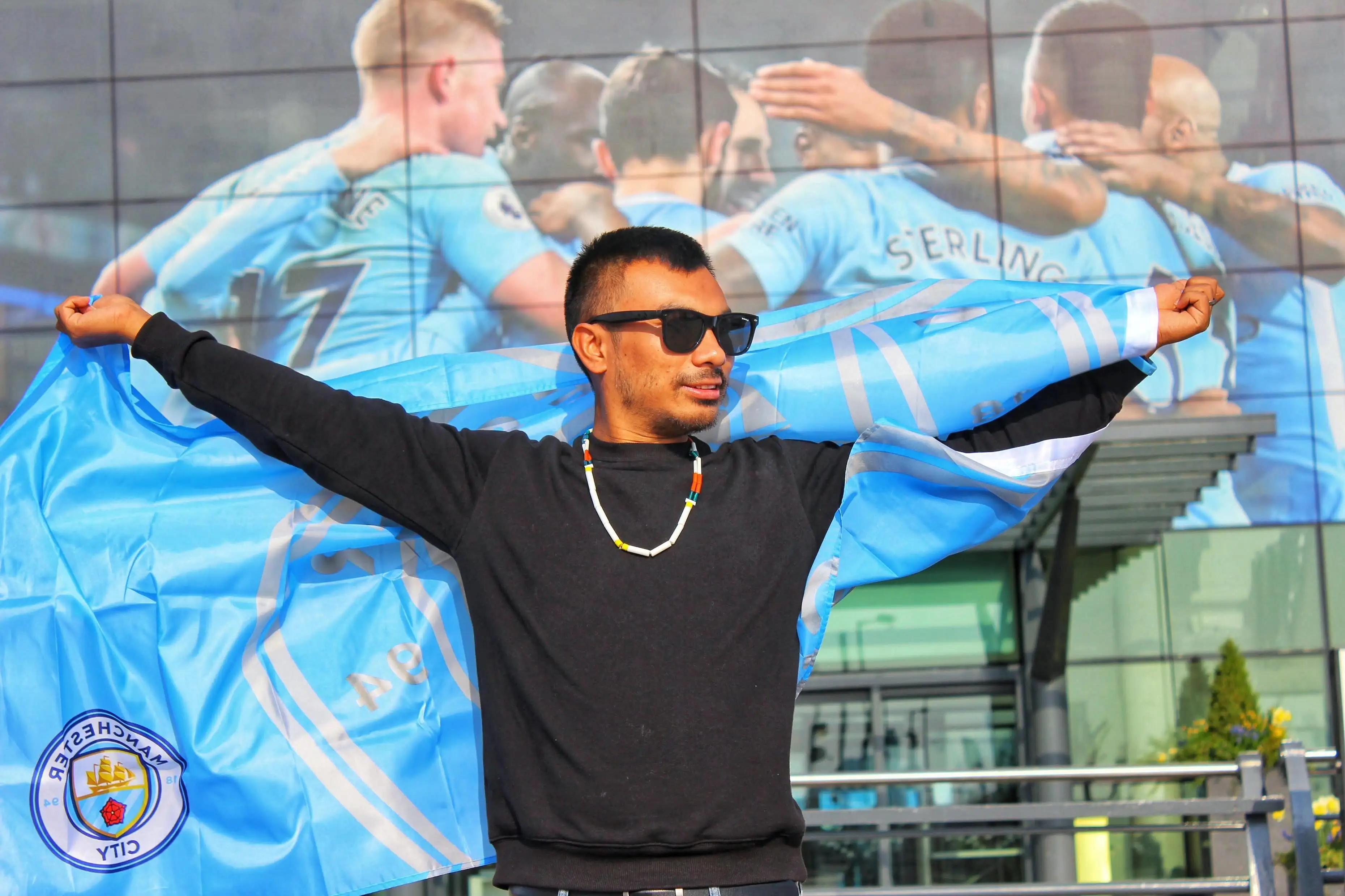 Worchihan Zingkhai poses outside the Etihad Stadium in Manchester.