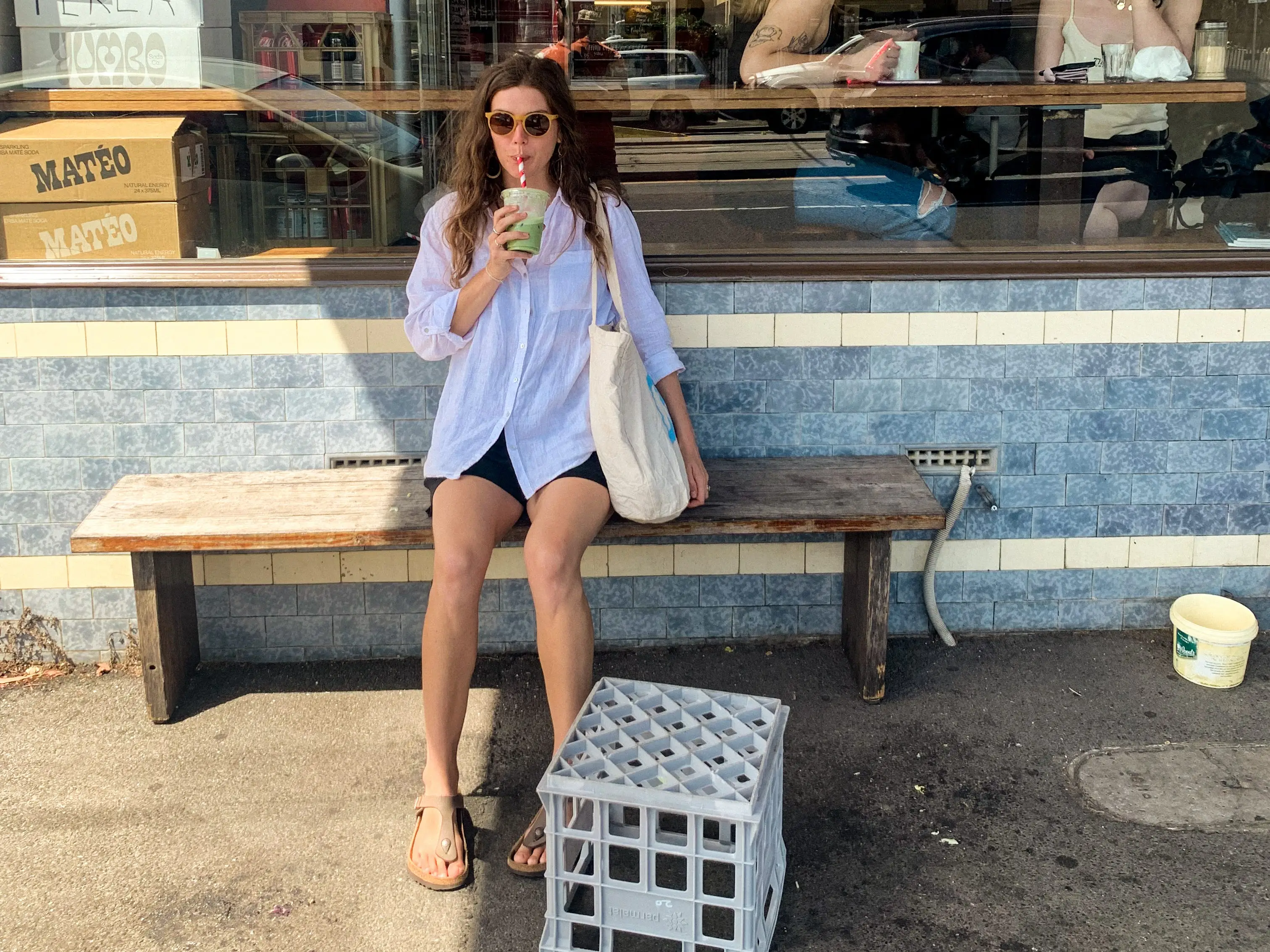 The author poses outside of a food spot.