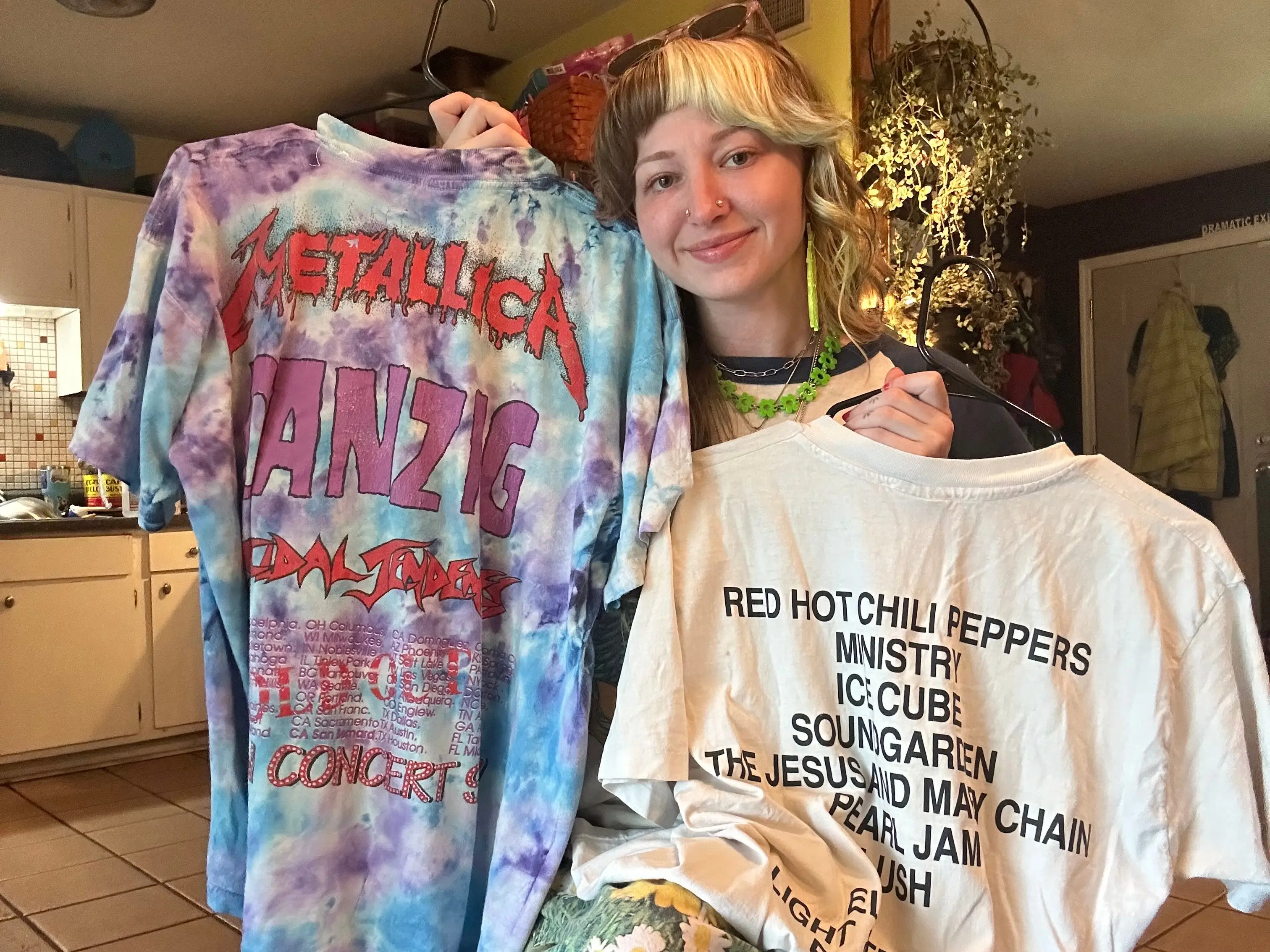 Woman holding vintage T-shirts