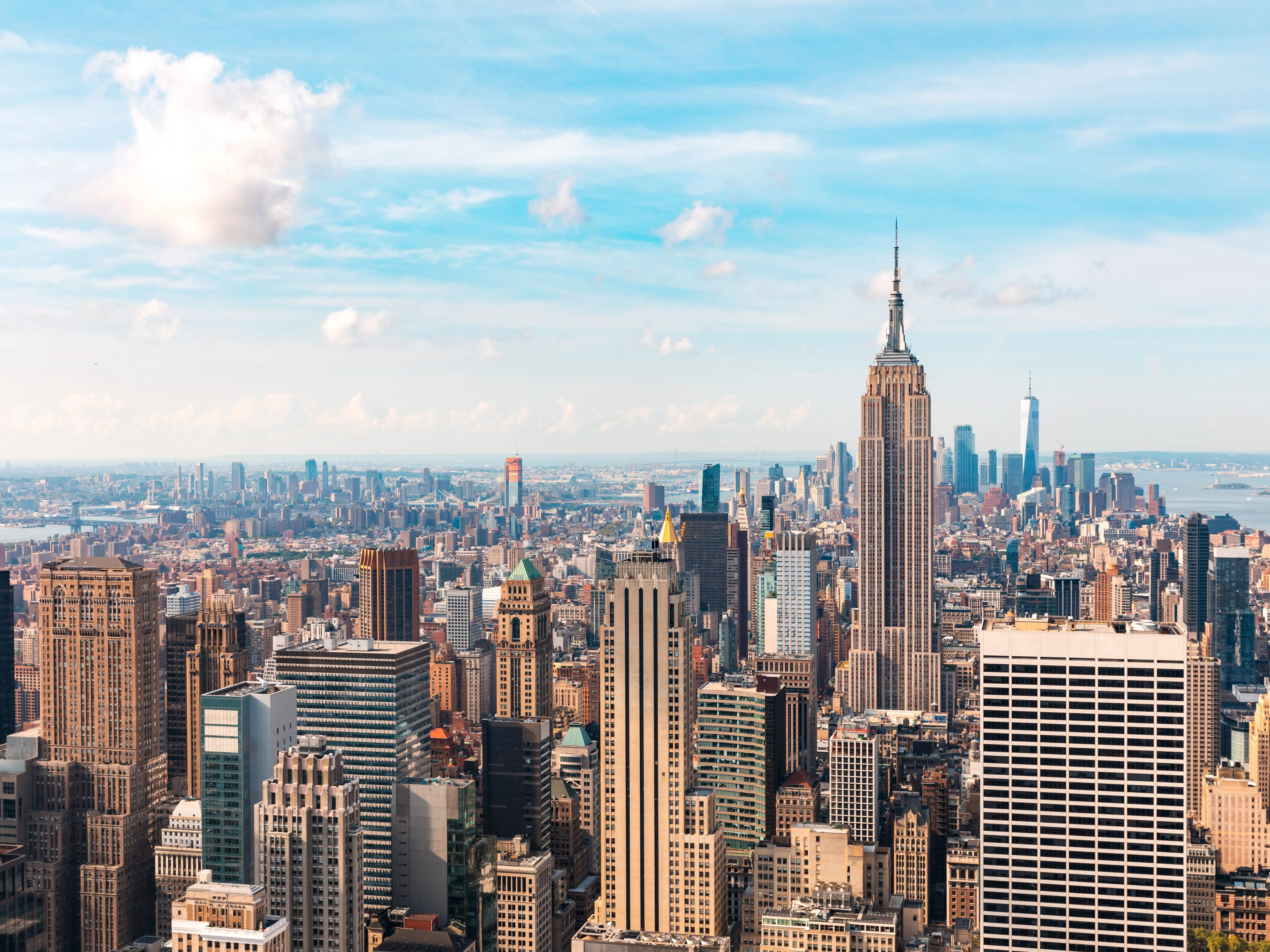 Iconic buildings overlooking bustling new york city with impressive architecture and vibrant energy in warm sunlight