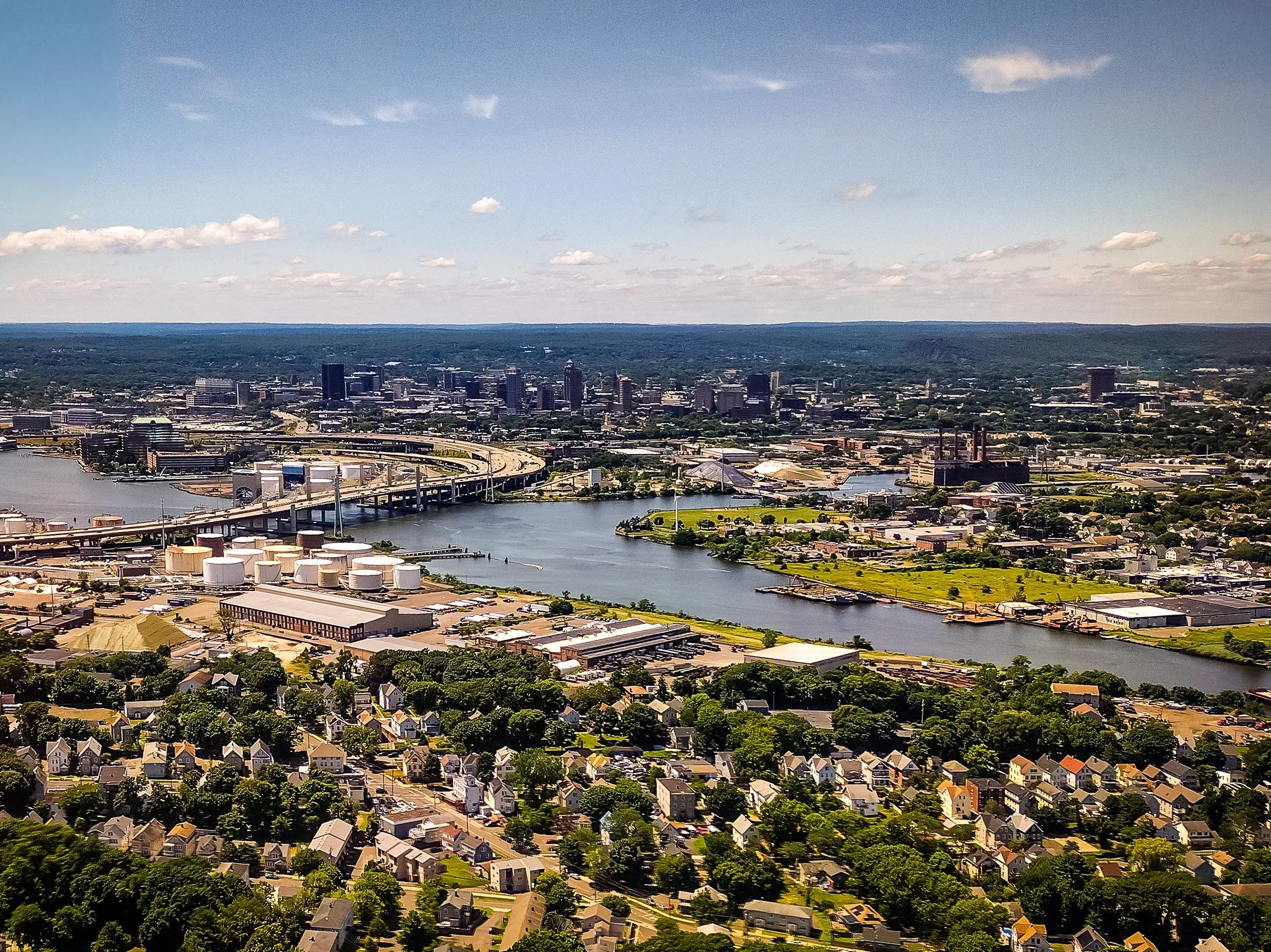 A stunning aerial stock photo of New Haven, Connecticut, showcasing the city's layout, architecture, and surrounding landscape from above. The image captures the urban and natural elements of the area, making it ideal for use in cityscapes, travel, and regional projects