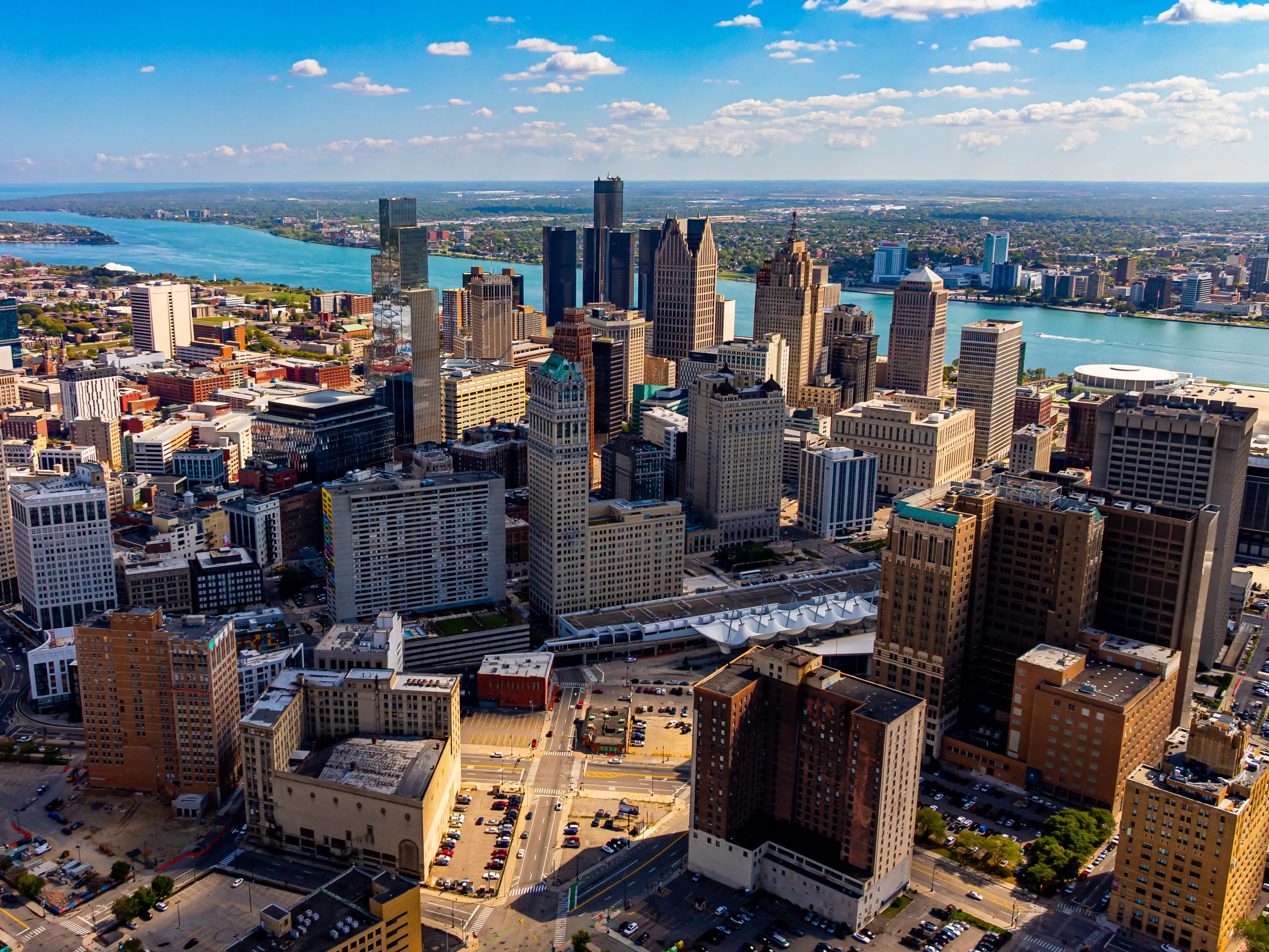 Downtown Detroit skyline and Detroit River. Drone aerial photo of downtown Detroit, Michigan with skyscrapers and the Detroit River on a sunny day.
