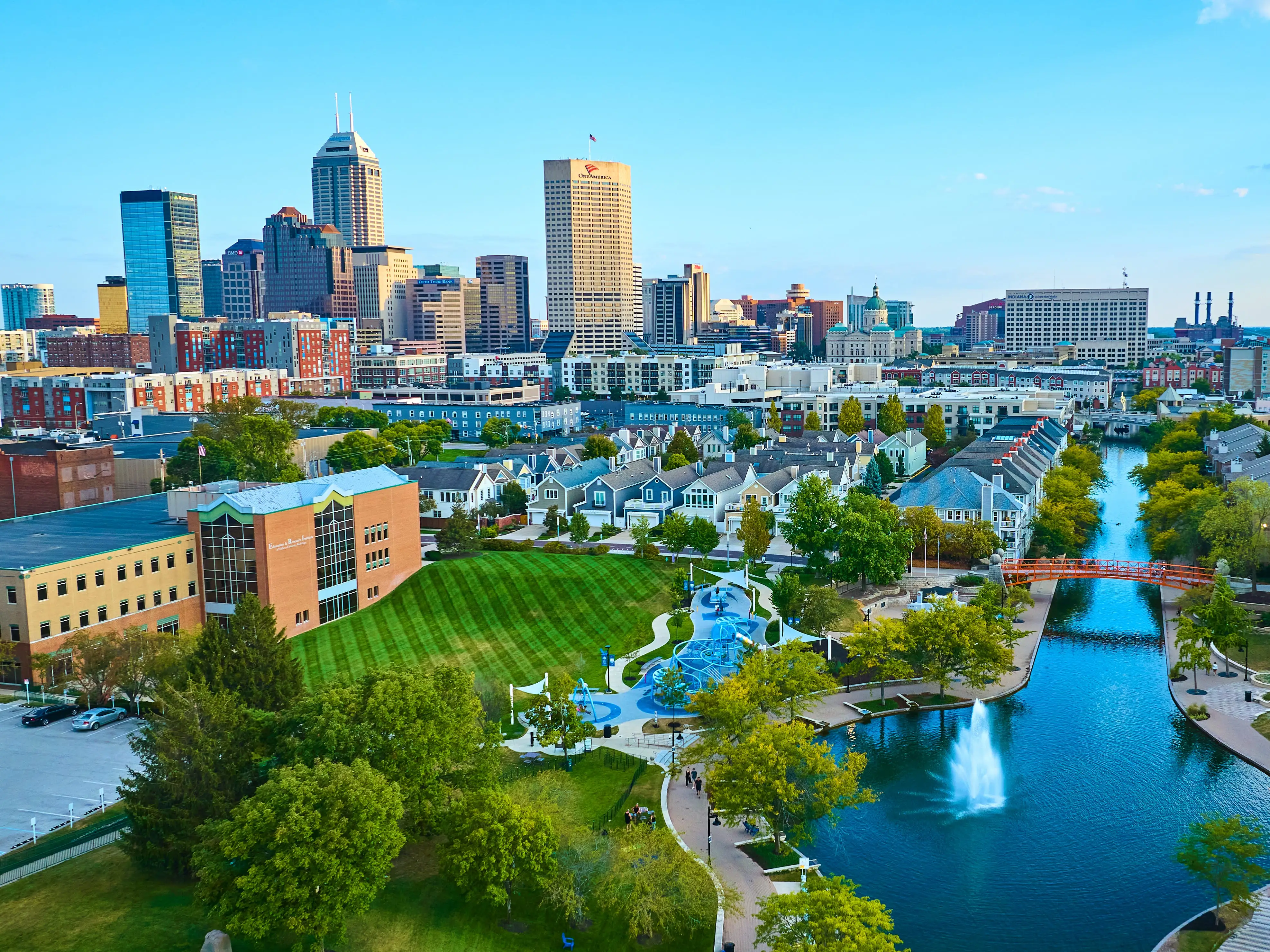 Aerial View of Vibrant Indianapolis Cityscape with Serene Park and Waterway at Golden Hour