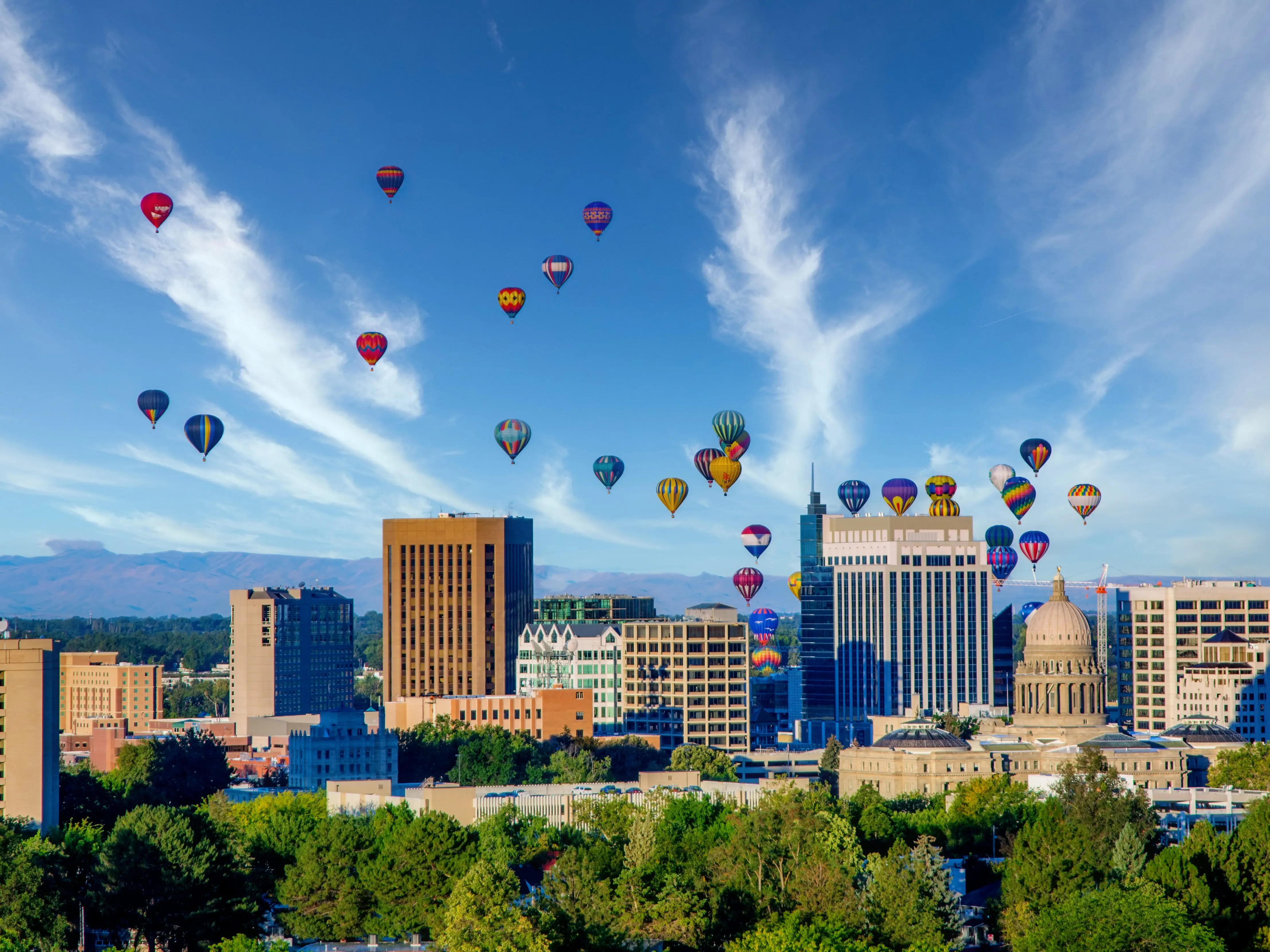 Cloudy sky over Boise with many hot air balloons