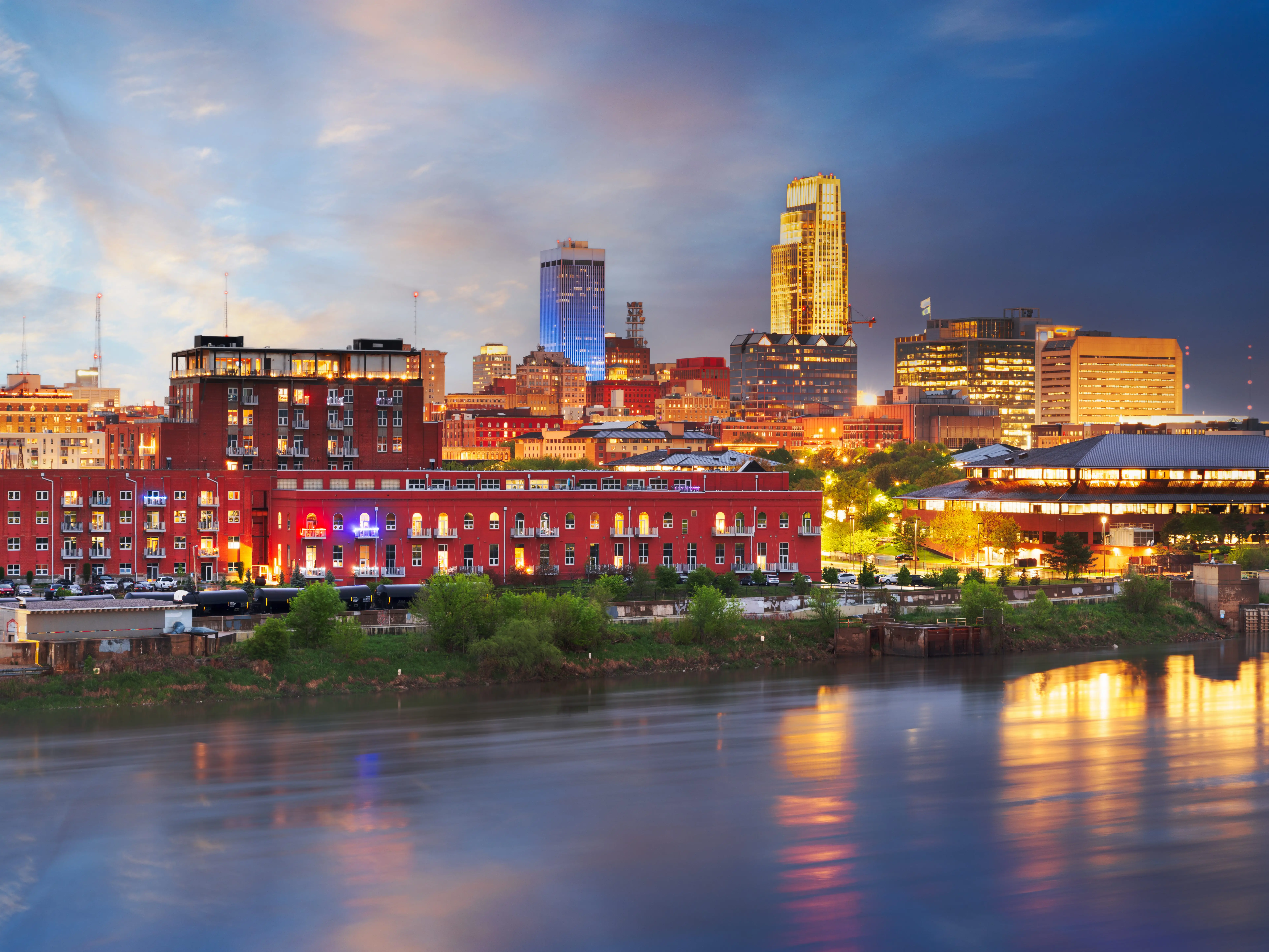 Omaha, Nebraska, USA downtown skyline on the Missouri River at night.