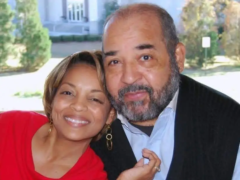 A man and his daughter wearing a red dress