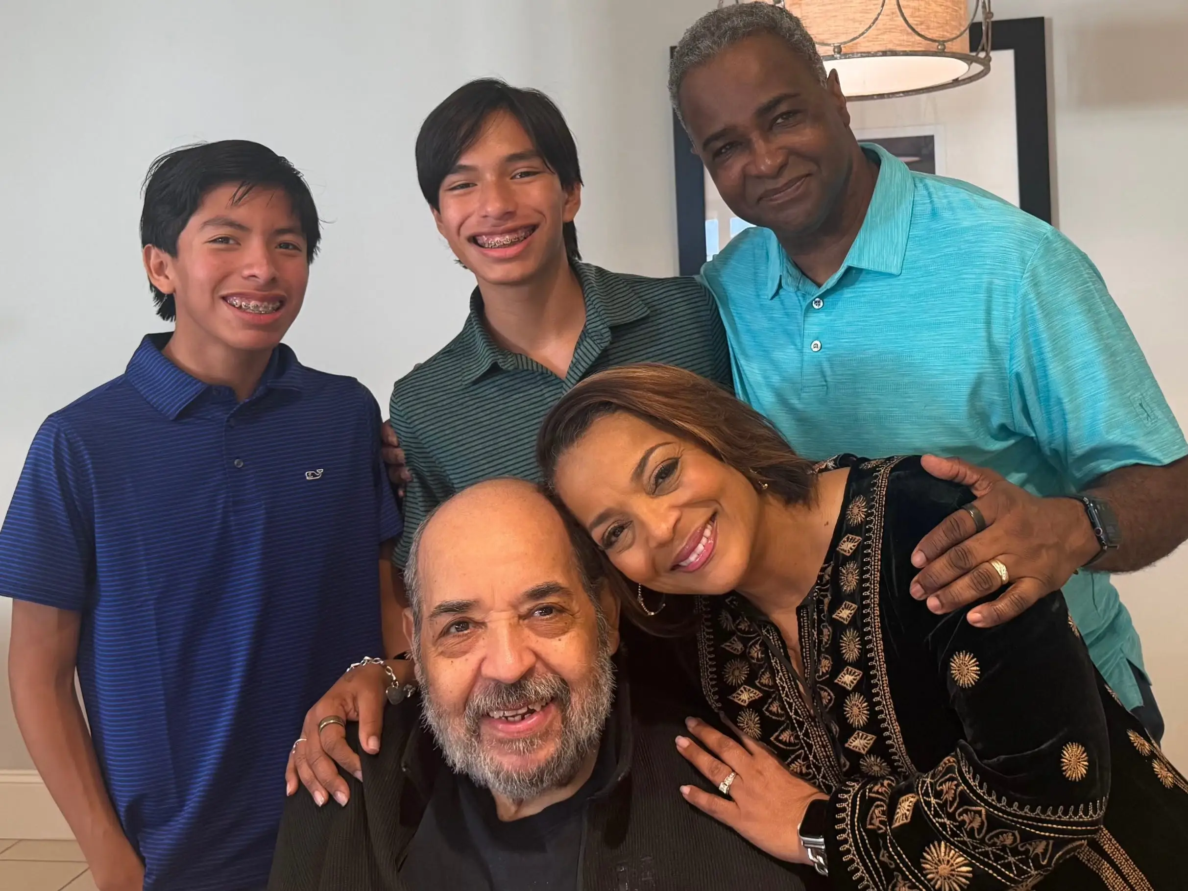A family of five people, including two teenagers.