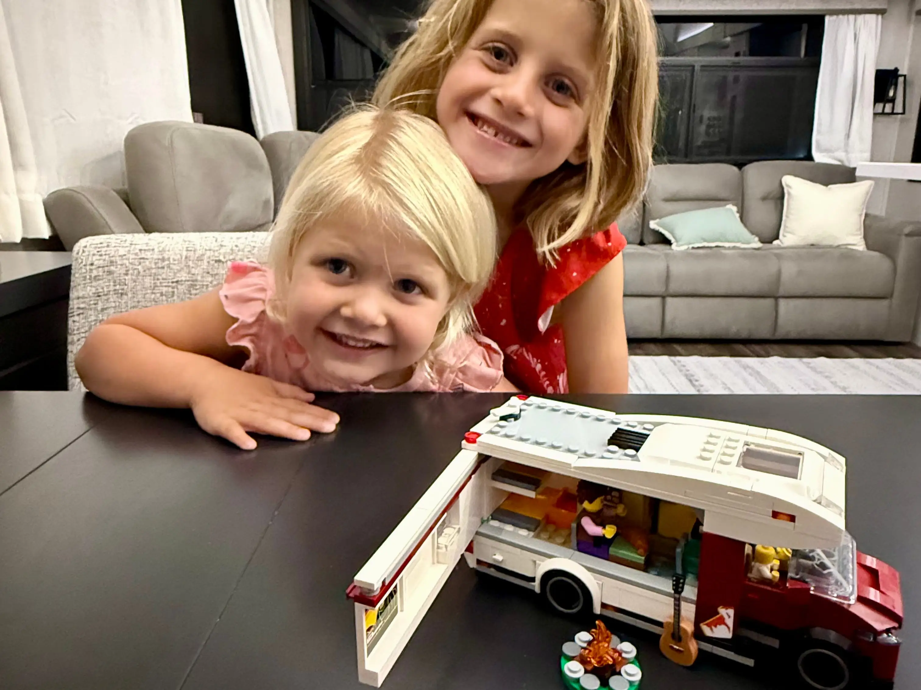 Jill and Derek Dooley's daughters next to a toy RV while sitting inside the family RV