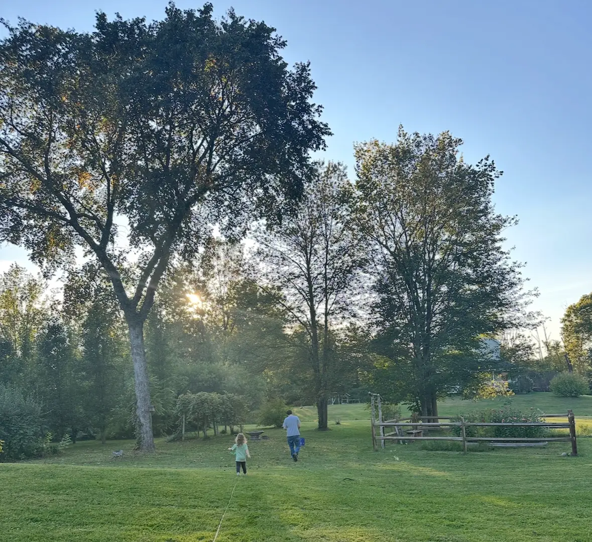 The authors husband and daughter walk in their New York backyard.