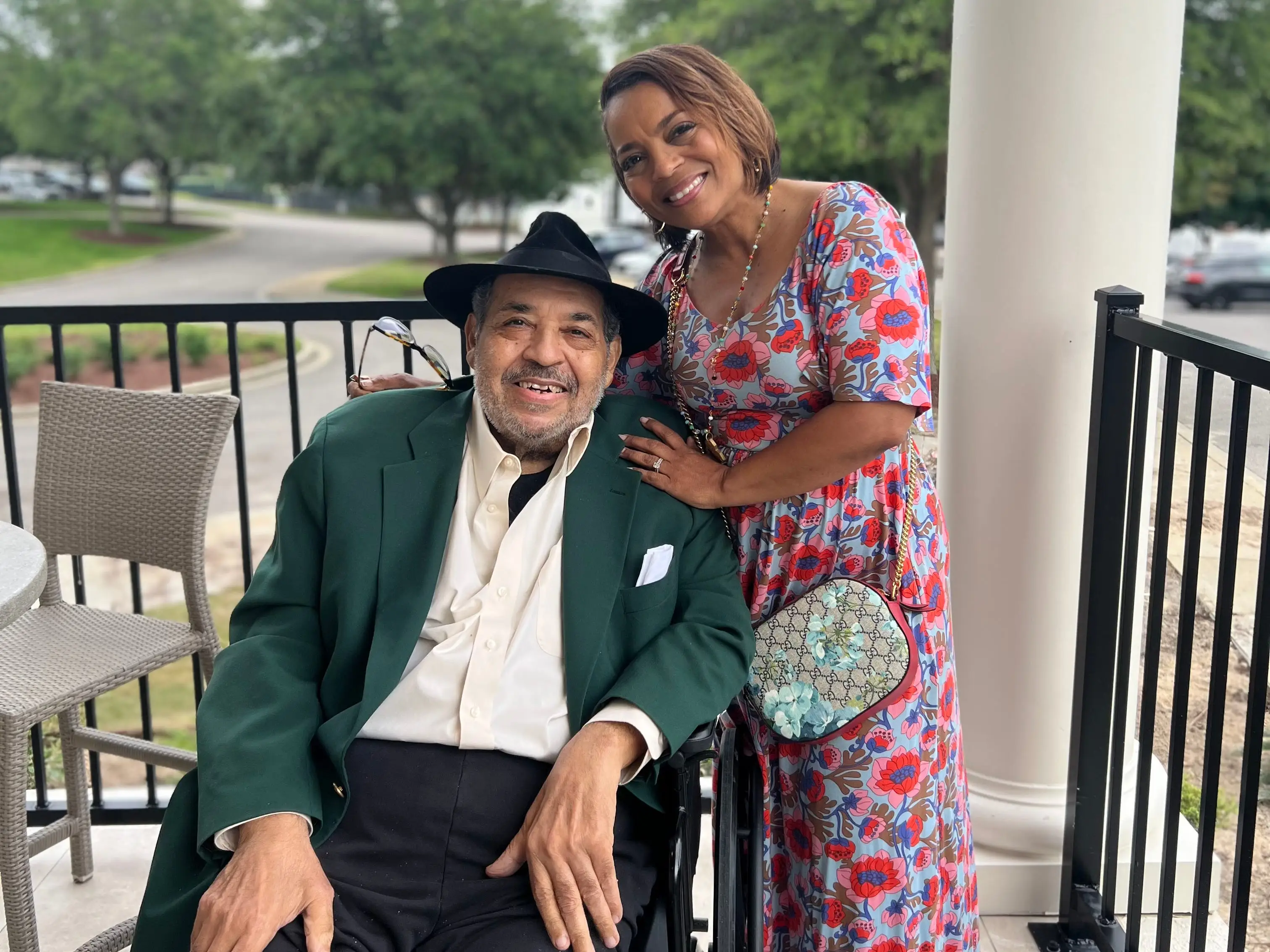 An older man in a wheelchair with his daughter
