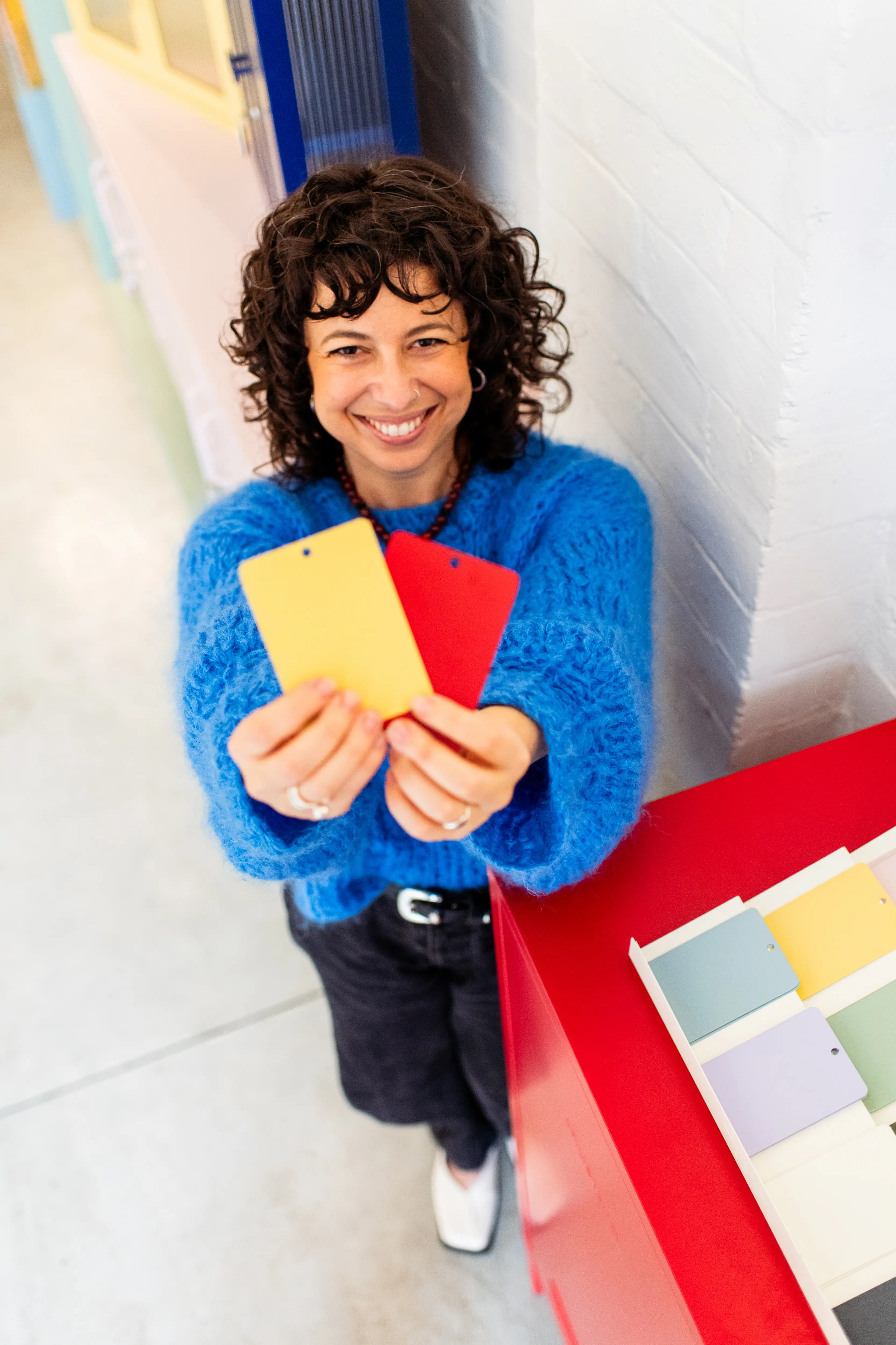Becca Stern, co-founder of Mustard Made, holds up some swatches in their Newcastle office.