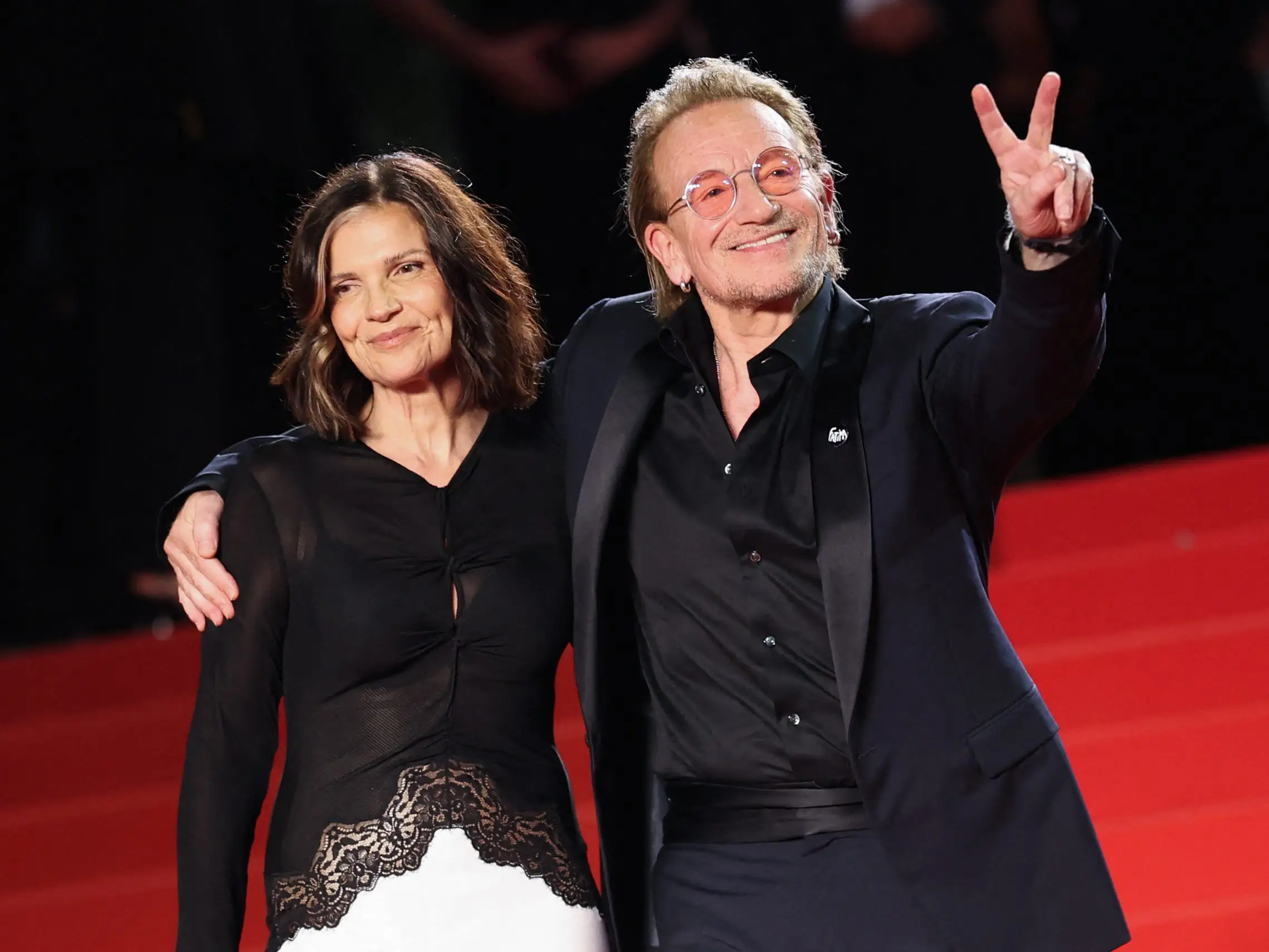 Irish singer-Songwriter and executive producer Bono (R) and his spouse Irish activist and businesswoman Ali Hewson leave after the screening of the film 