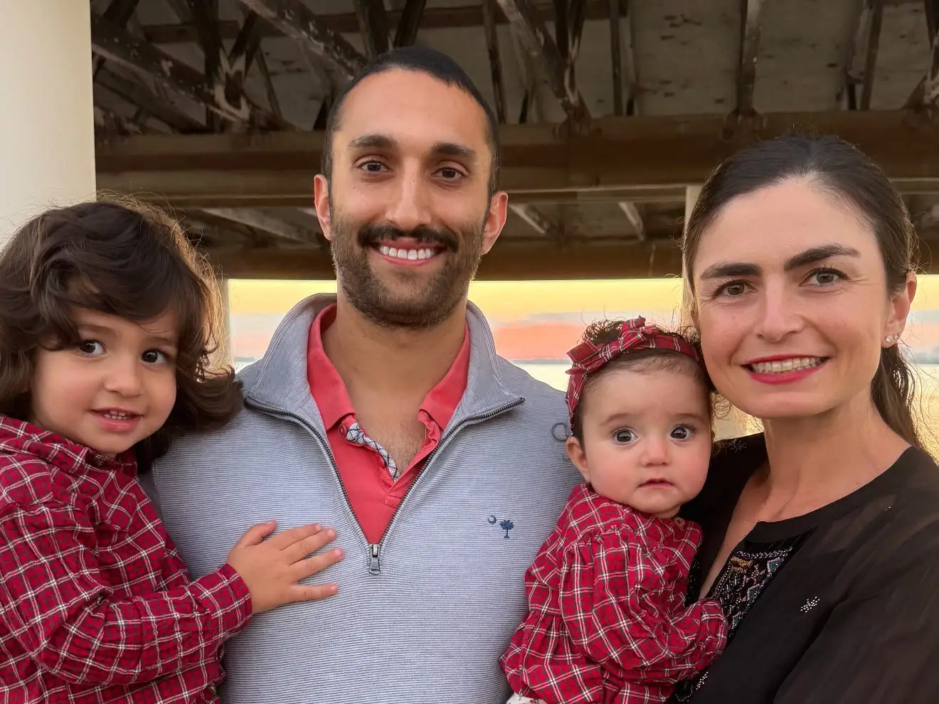 The writer, her husband, and her two kids in matching red shirts.