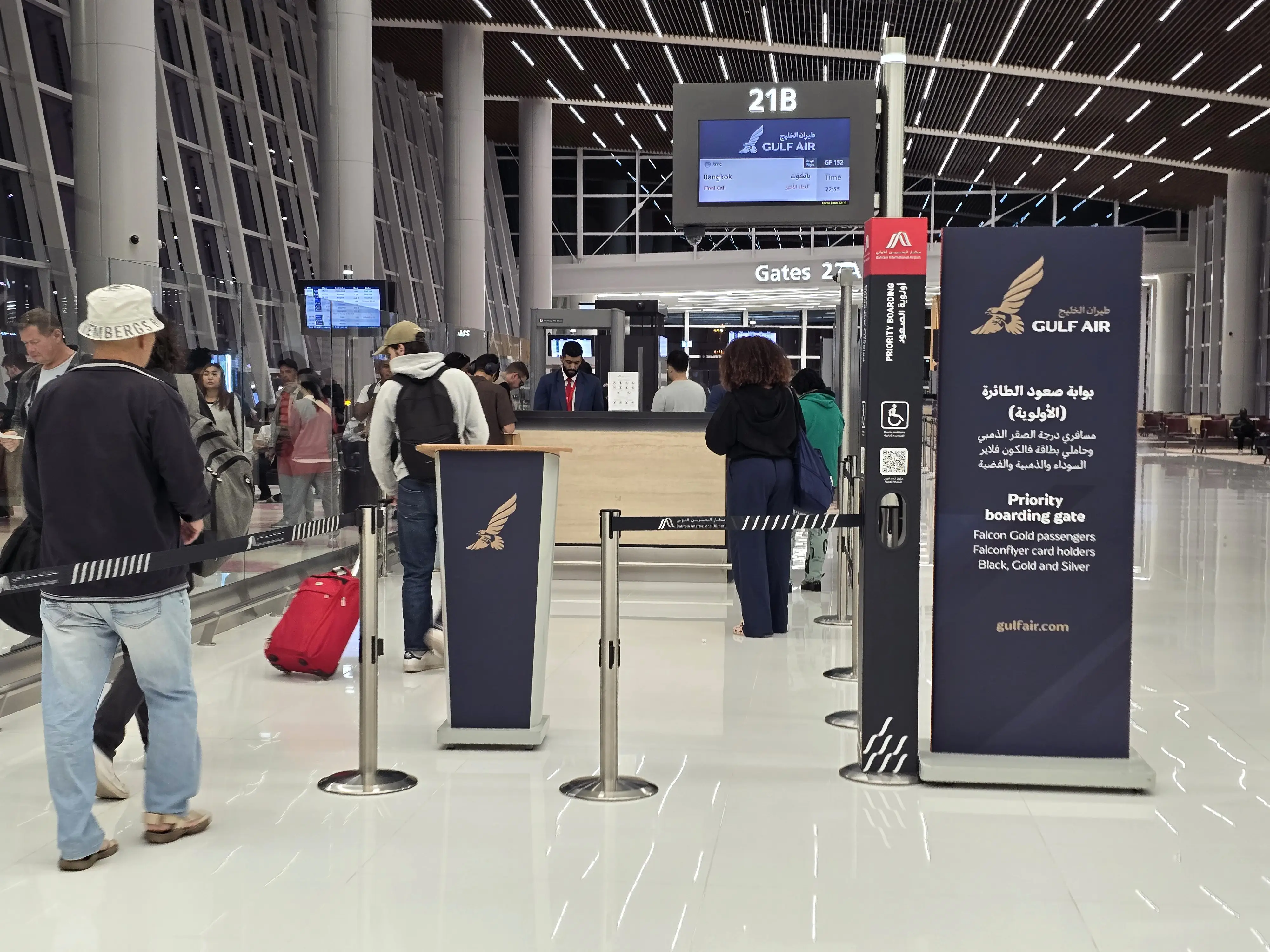 Boarding gate in Bahrain with a sign for priority passengers.