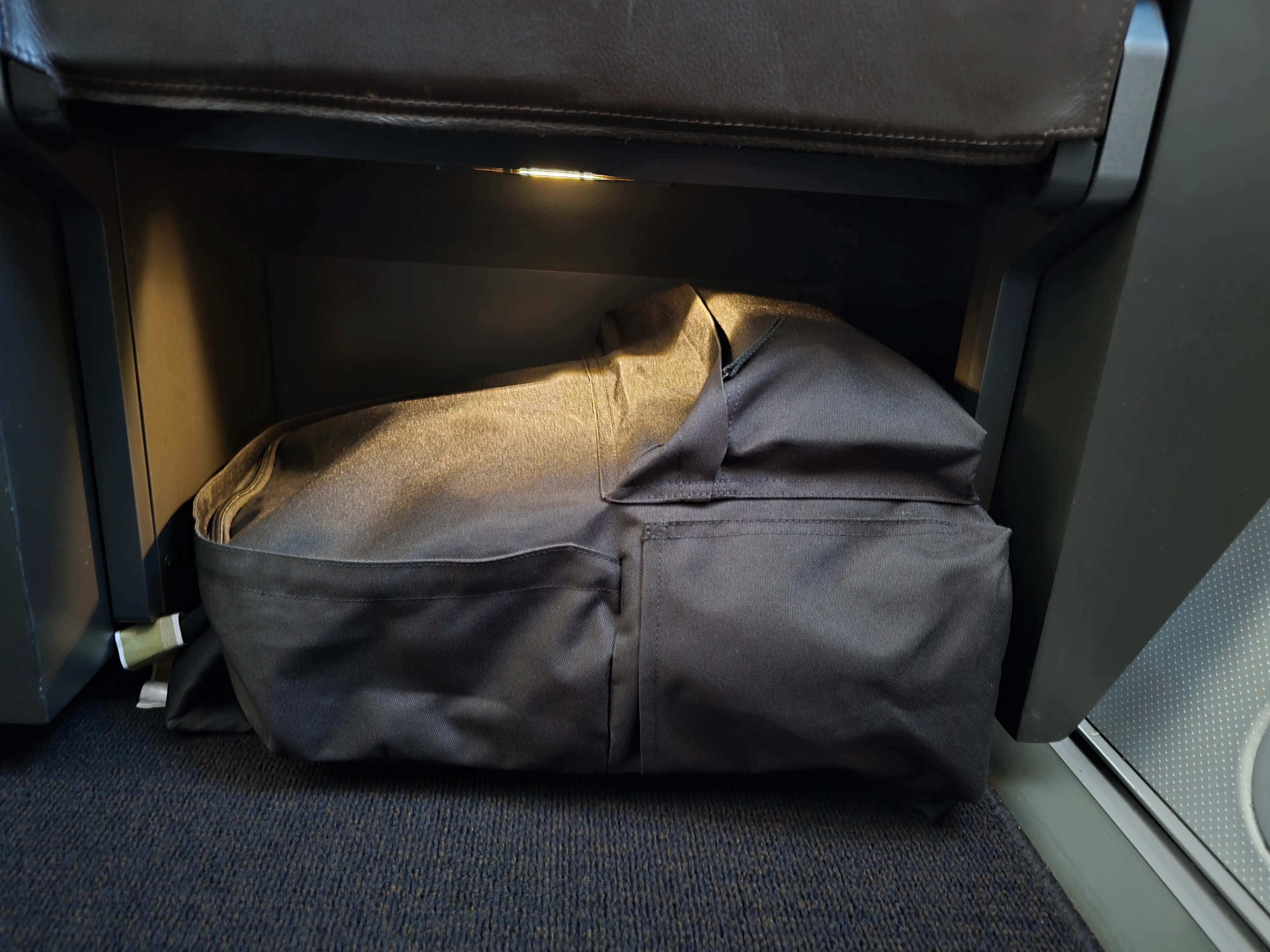 The author's backpack under the seat.