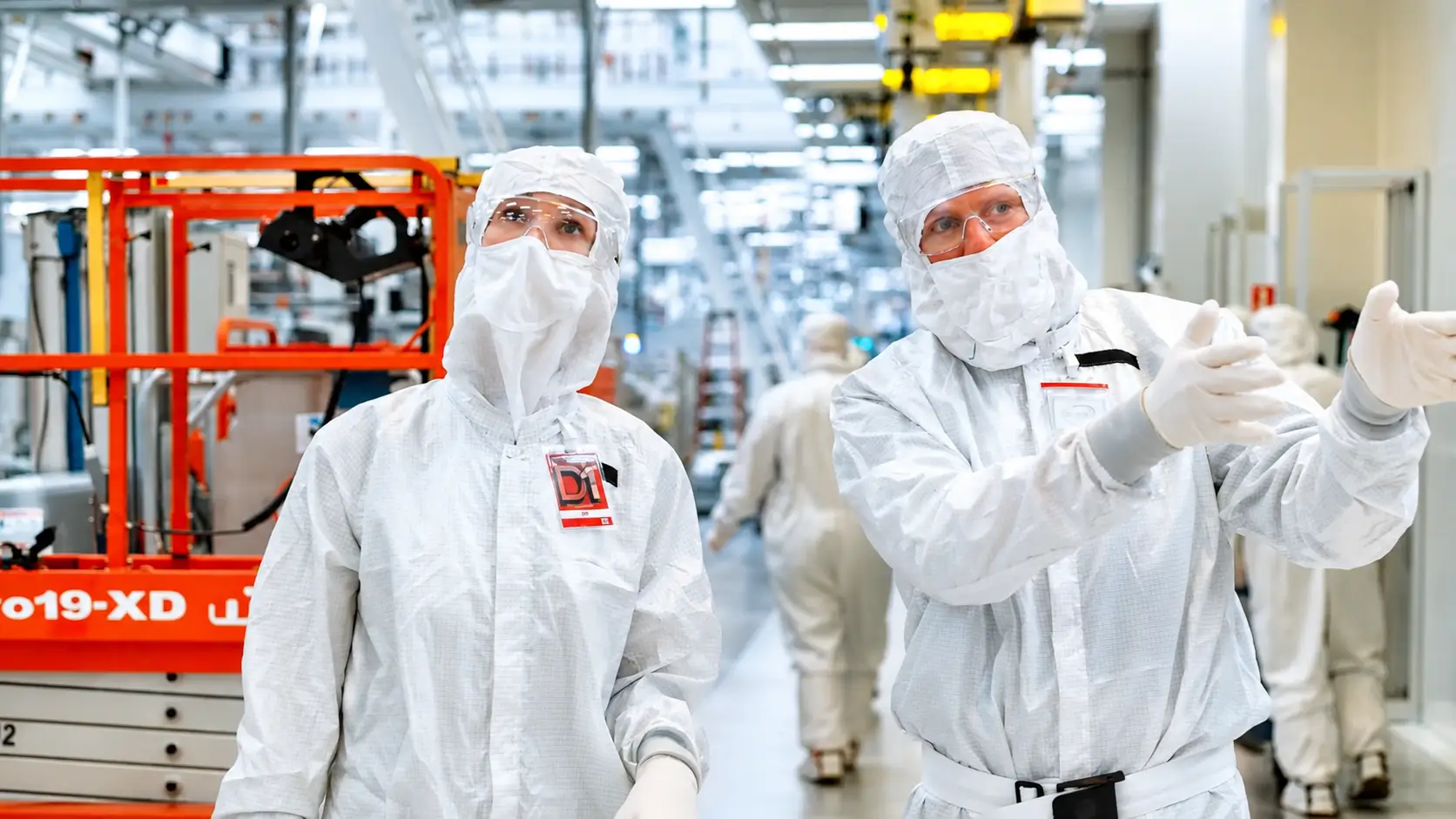 Producer Olivia Nemec and Intel's Chris Auth walk through the main hallway in the chip fabrication plant.