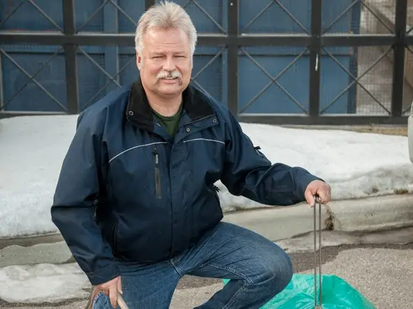 Brian Winch sweeping a parking lot