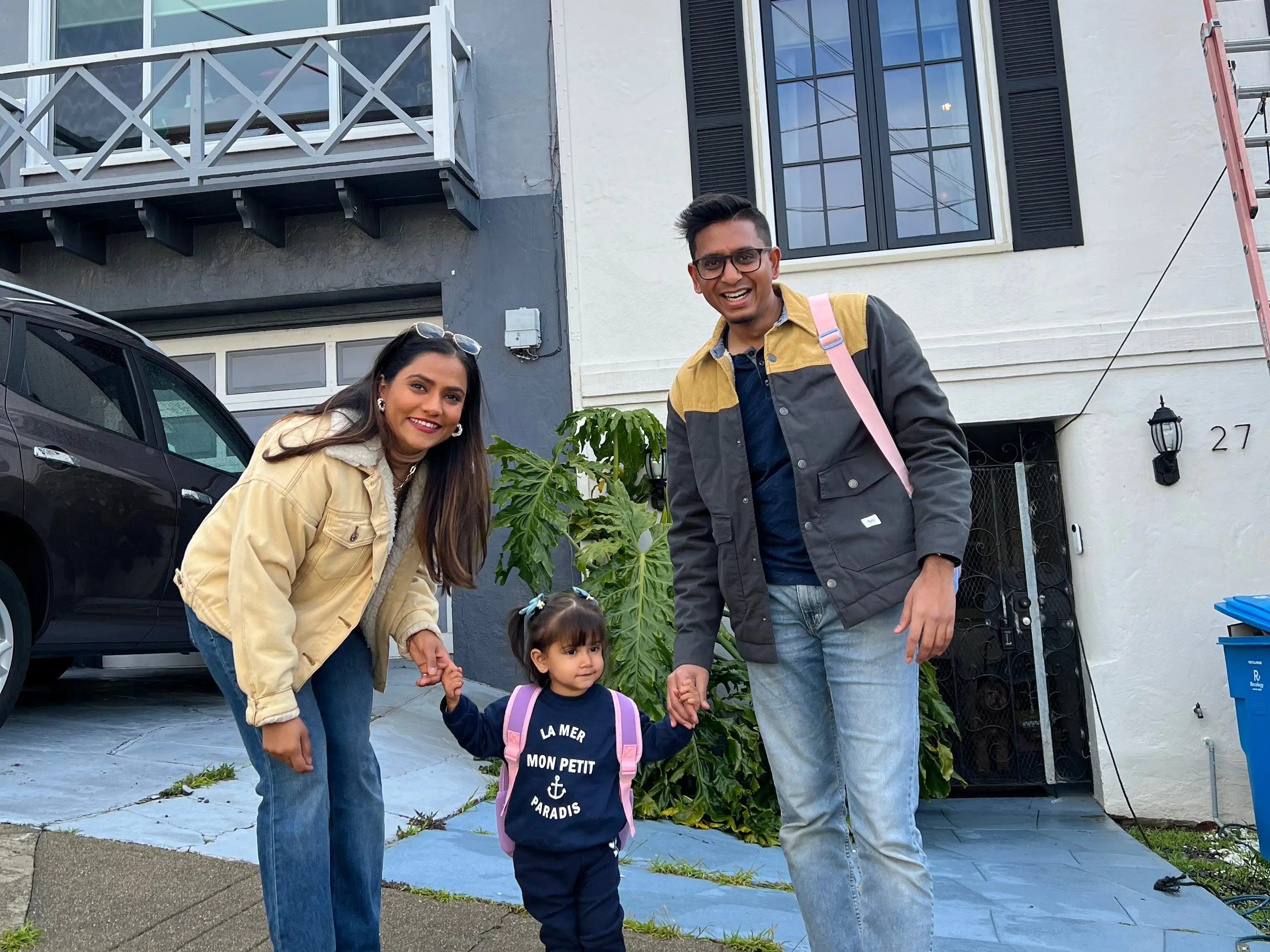 A family standing outside a home in San Francisco.