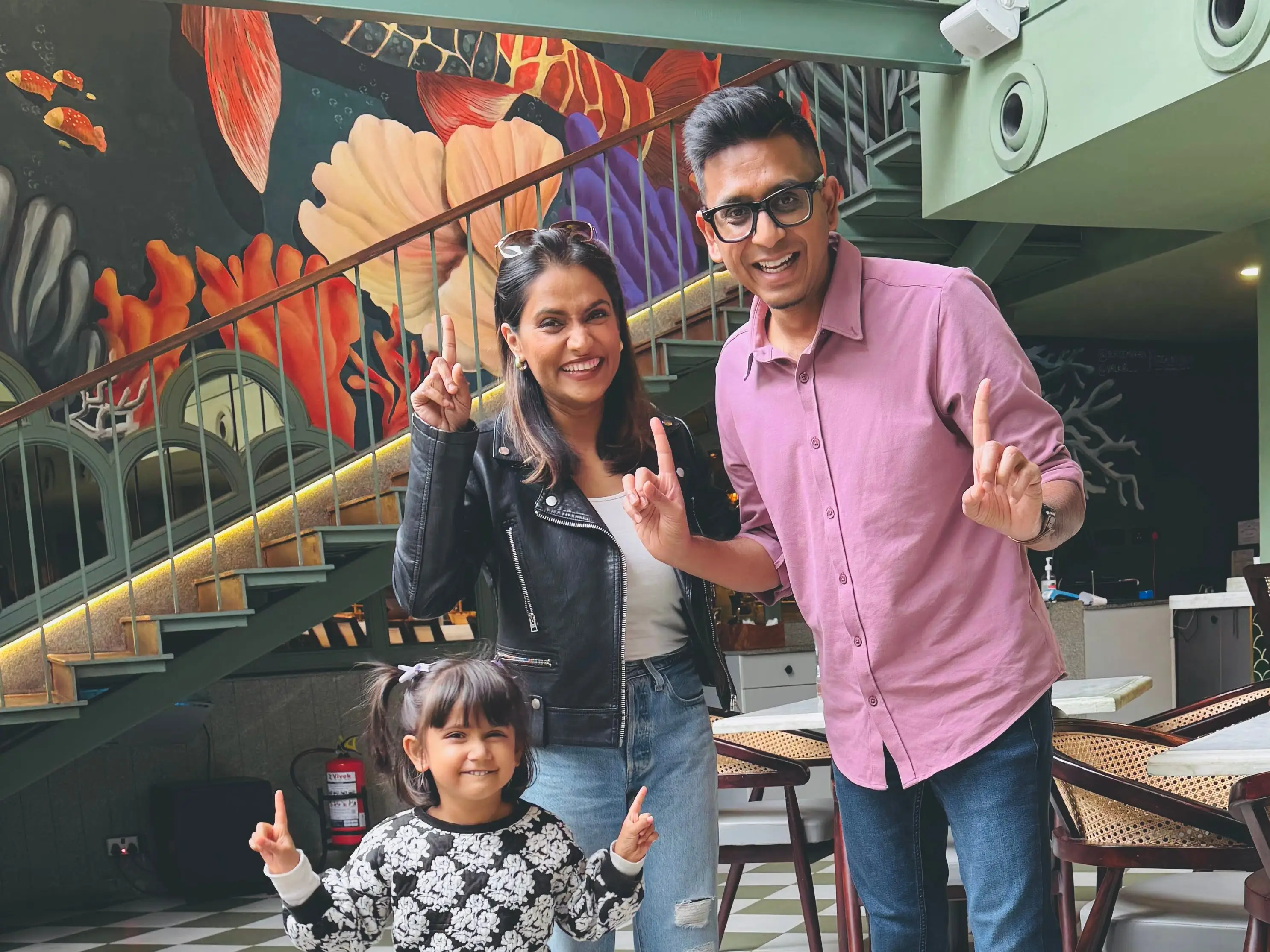 A family dancing at a restaurant.