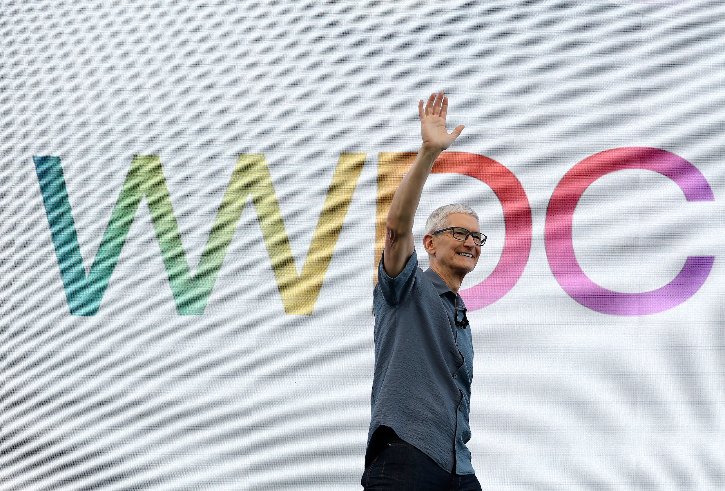 Tim Cook waves during Apple's 2025 WWDC