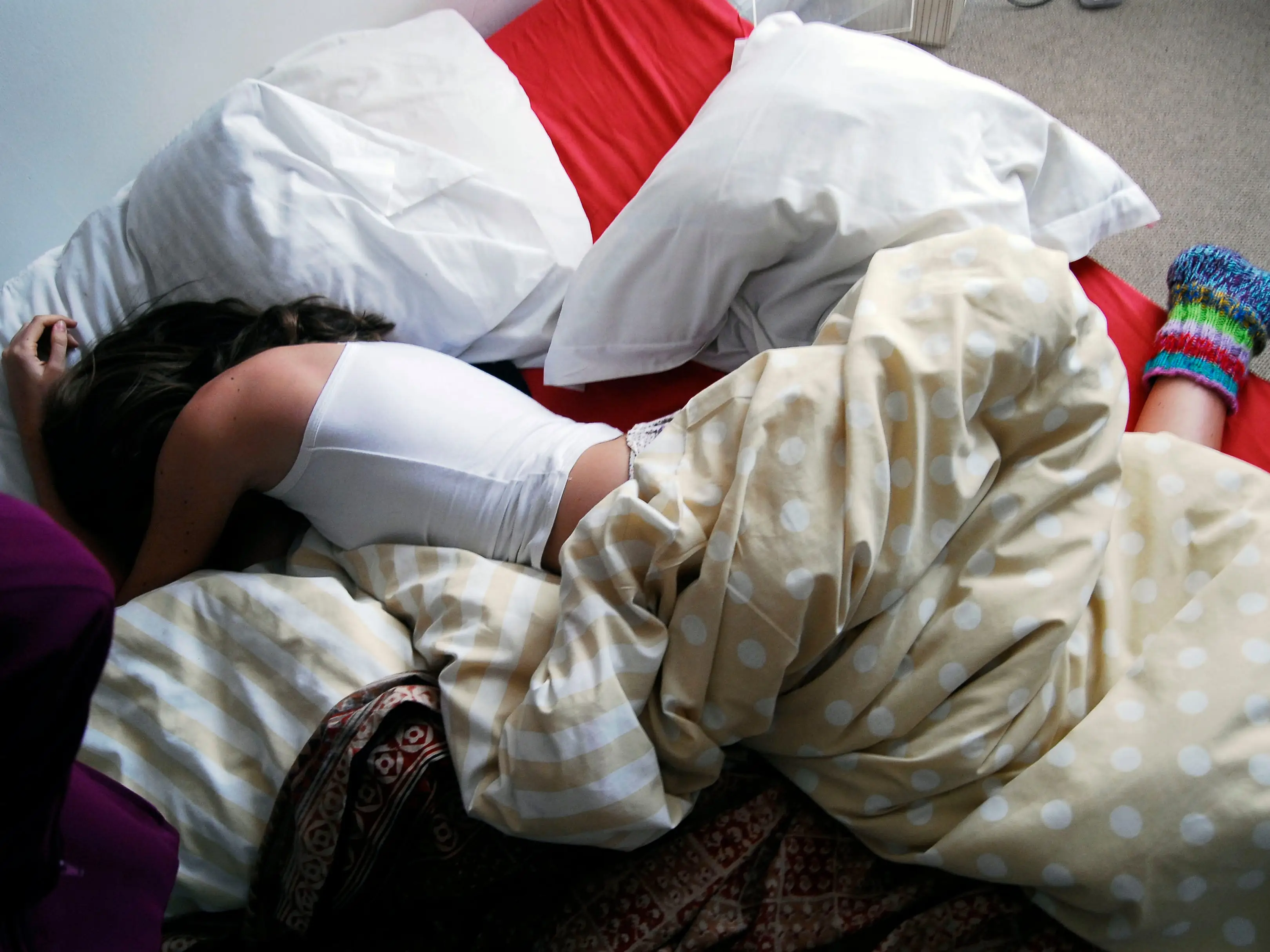 a teenager asleep in bed