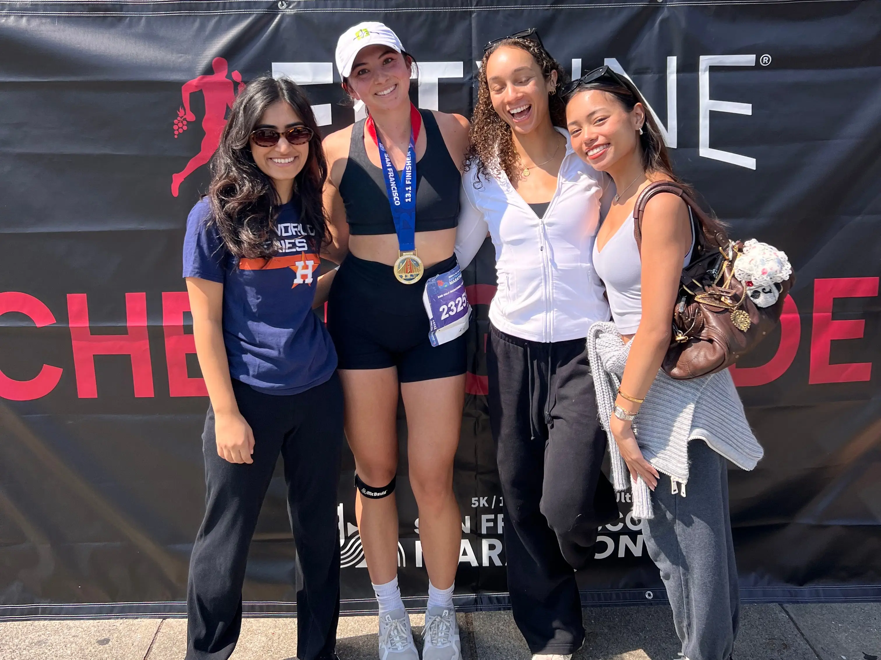 A woman with her three roommates after she finished the San Francisco Marathon.