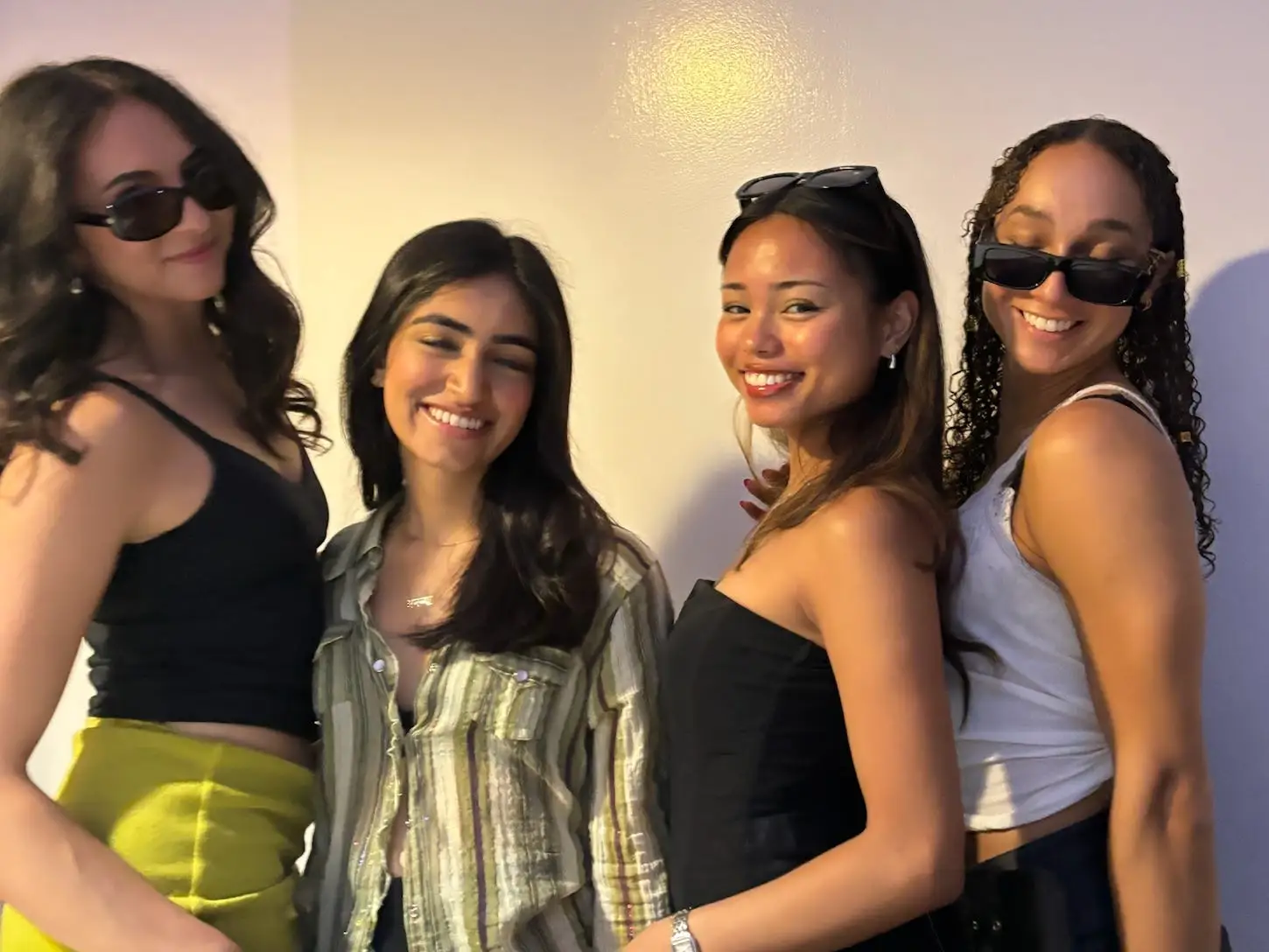 Four roommates posing together at a house party in San Francisco.