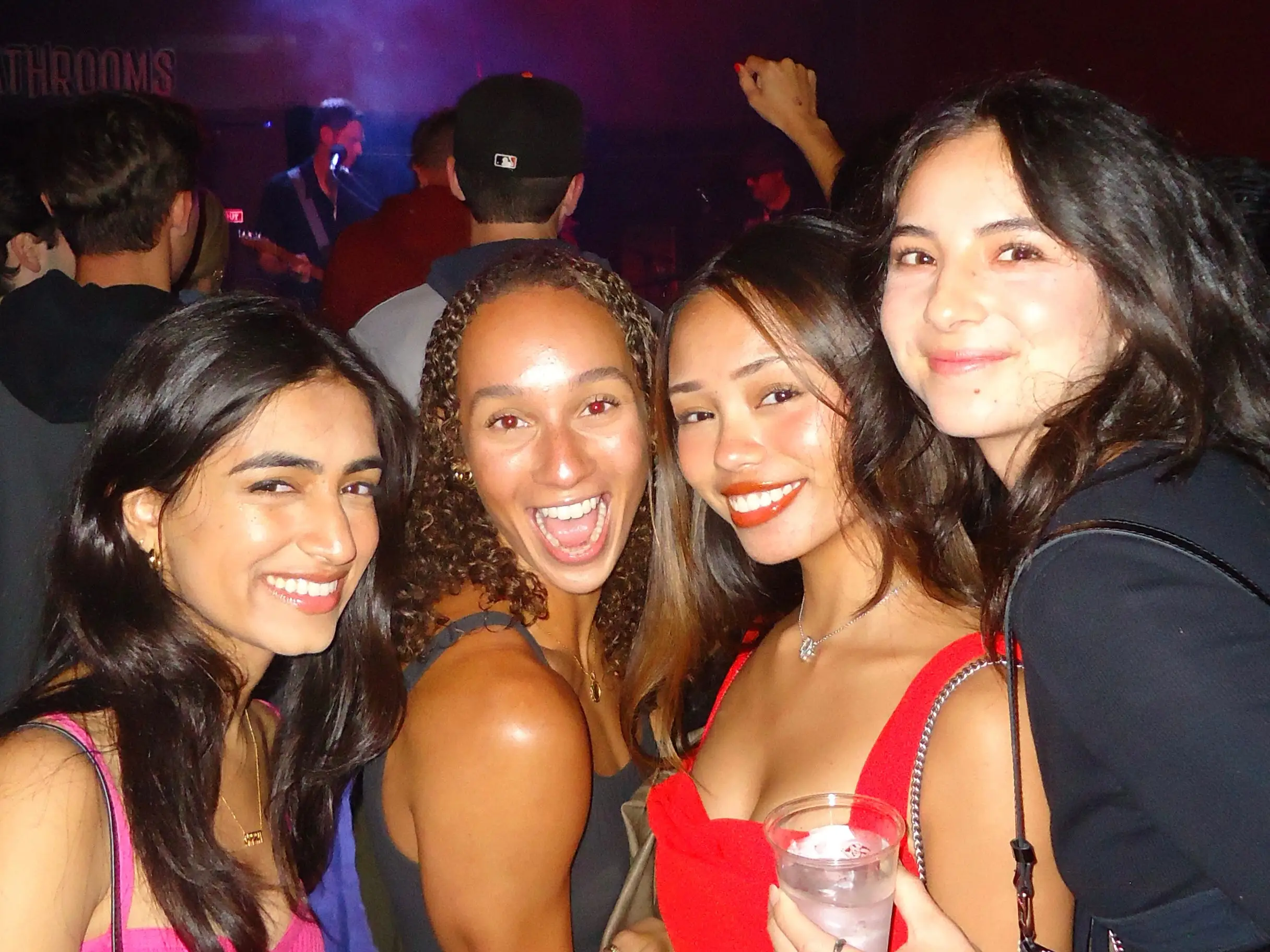 Four roommates photographed together at a bar.
