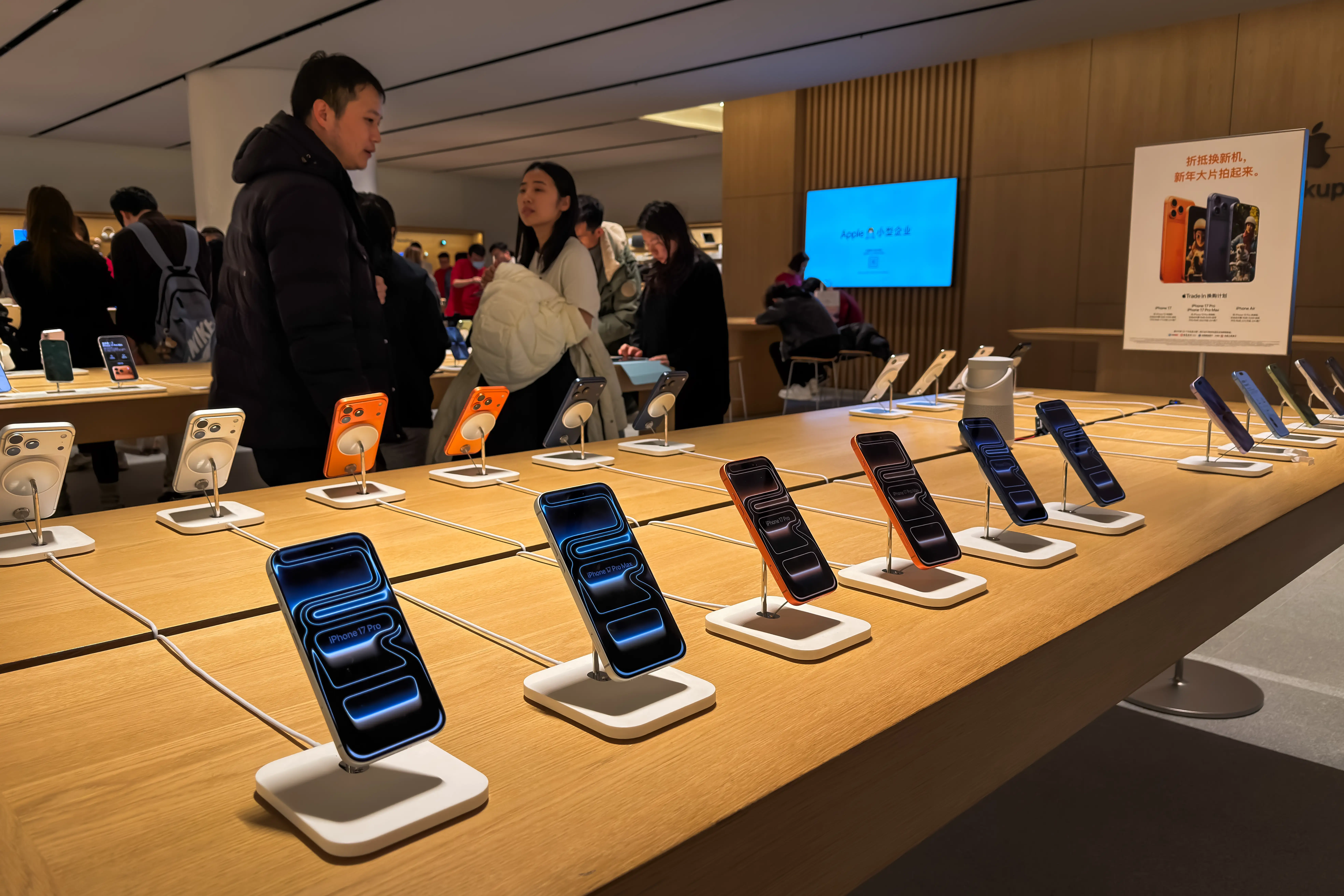 Customers shop in an Apple store in China.