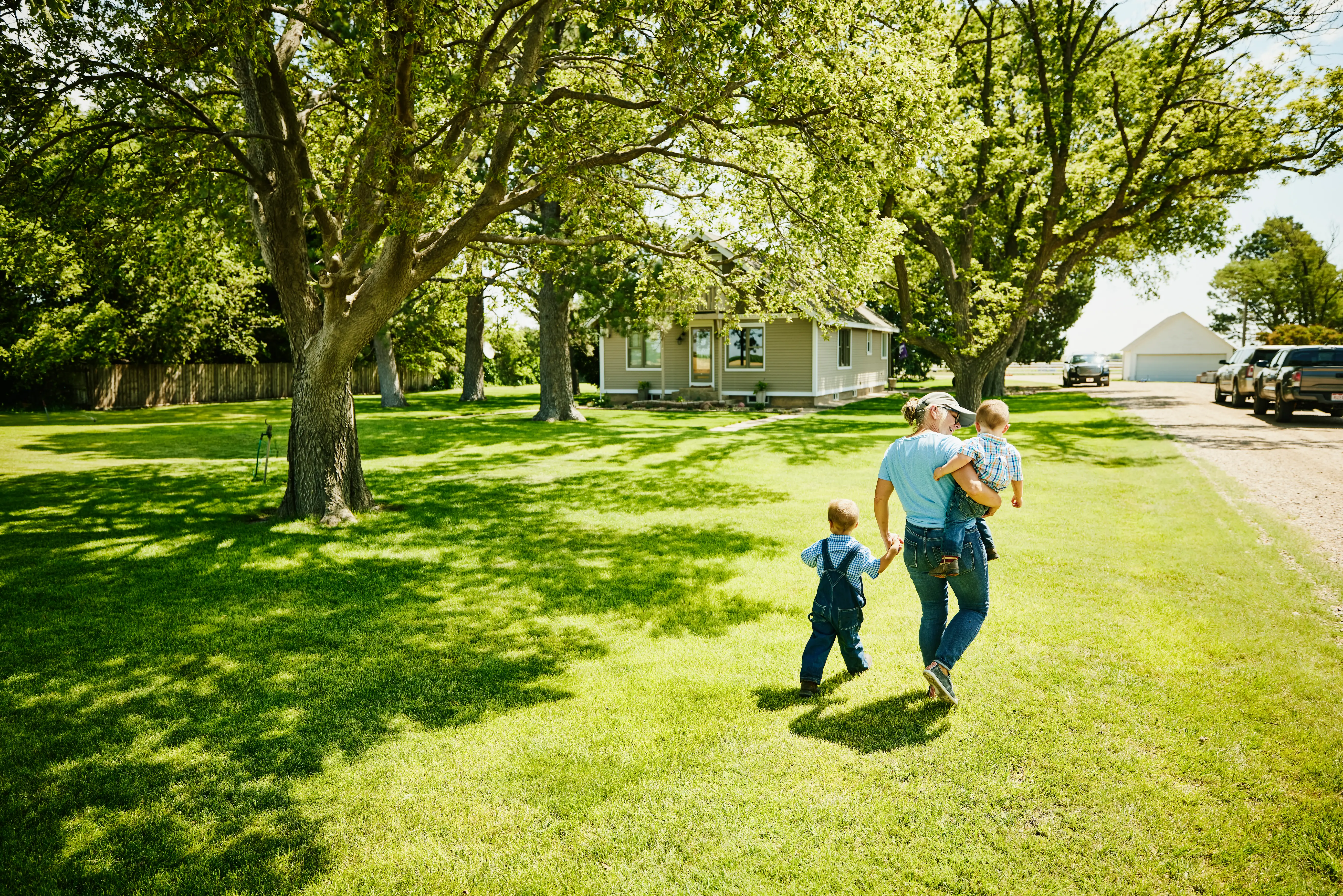 A grandma walking with her two grandchildren.