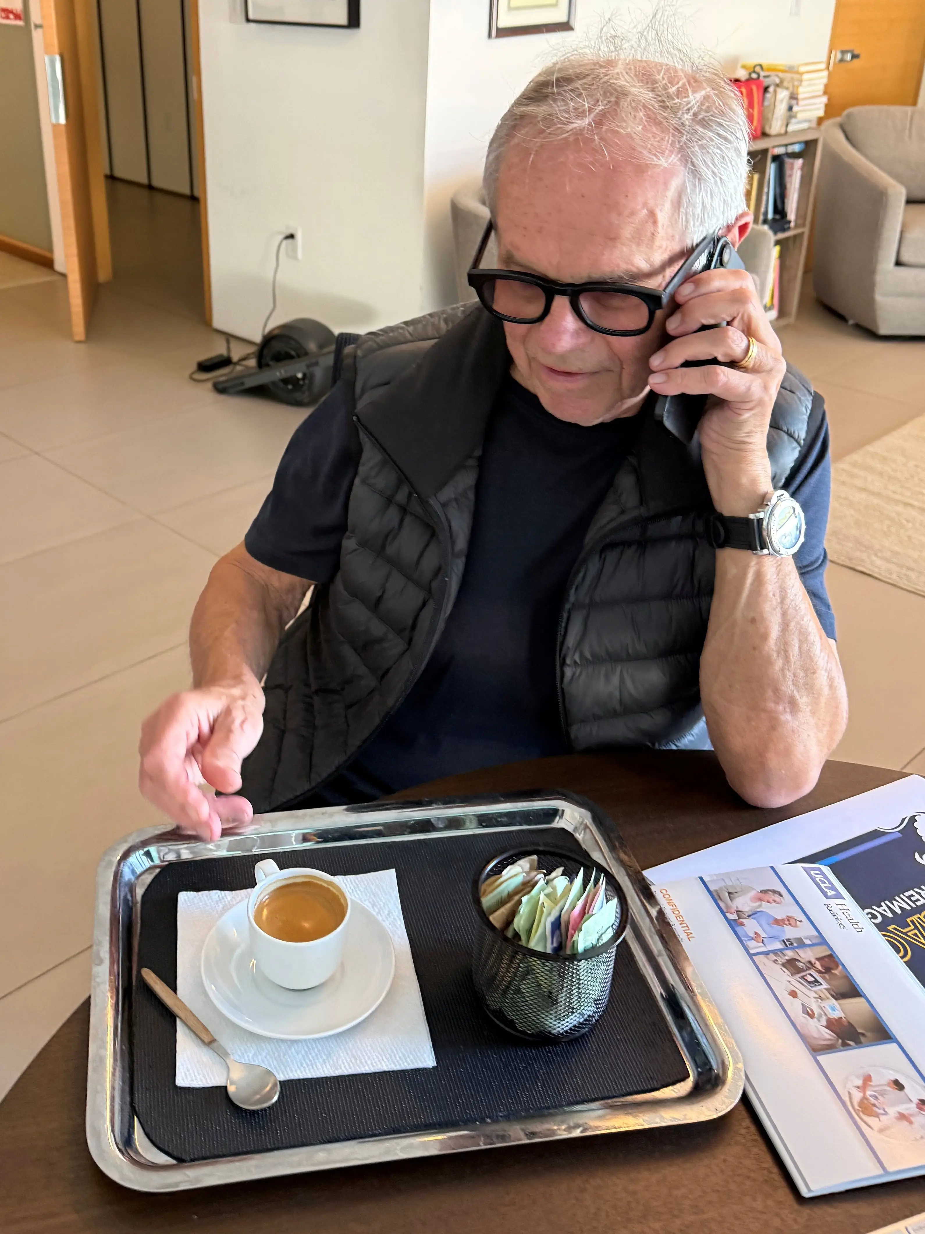 Wolfgang Puck in his office drinking espresso.