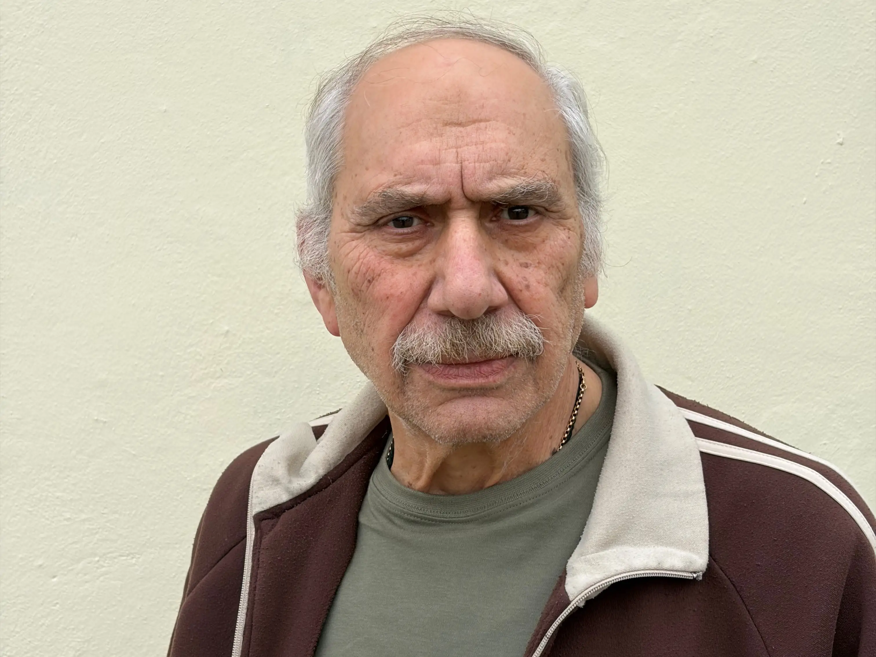 A senior wearing a jacket that says Australia on it.