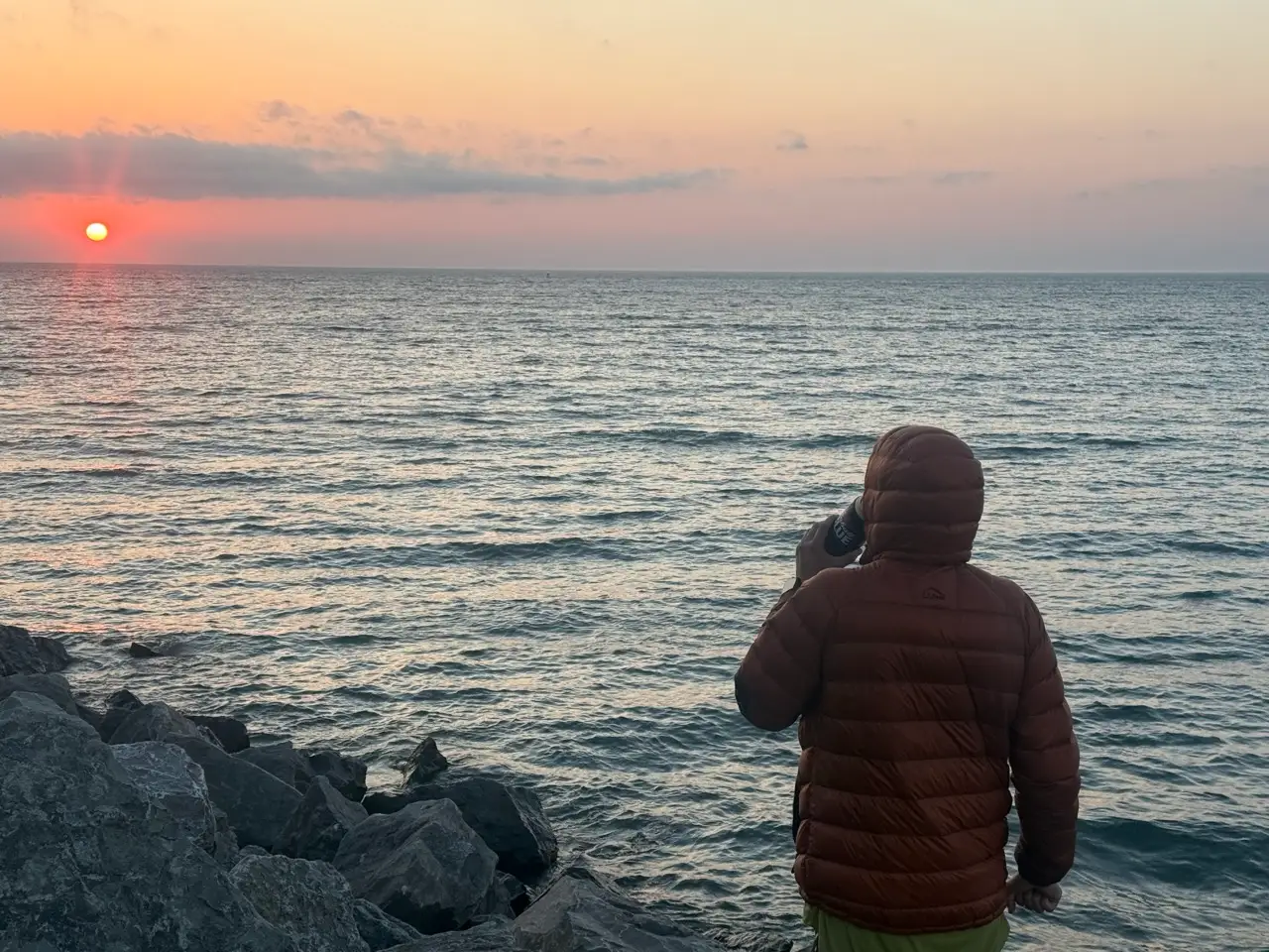 Man watching sunset over lake
