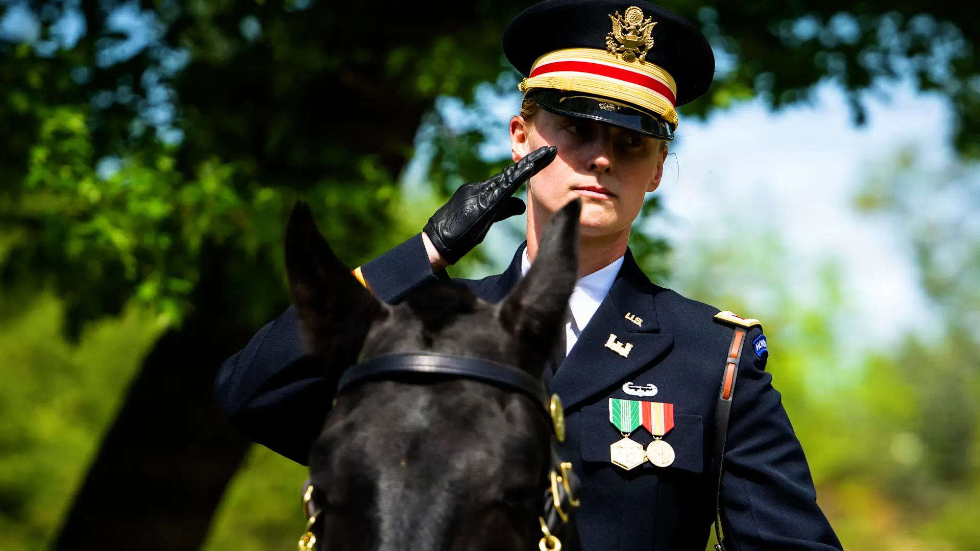 Woman in uniform atop a horse at Arlington National Cemetery.
