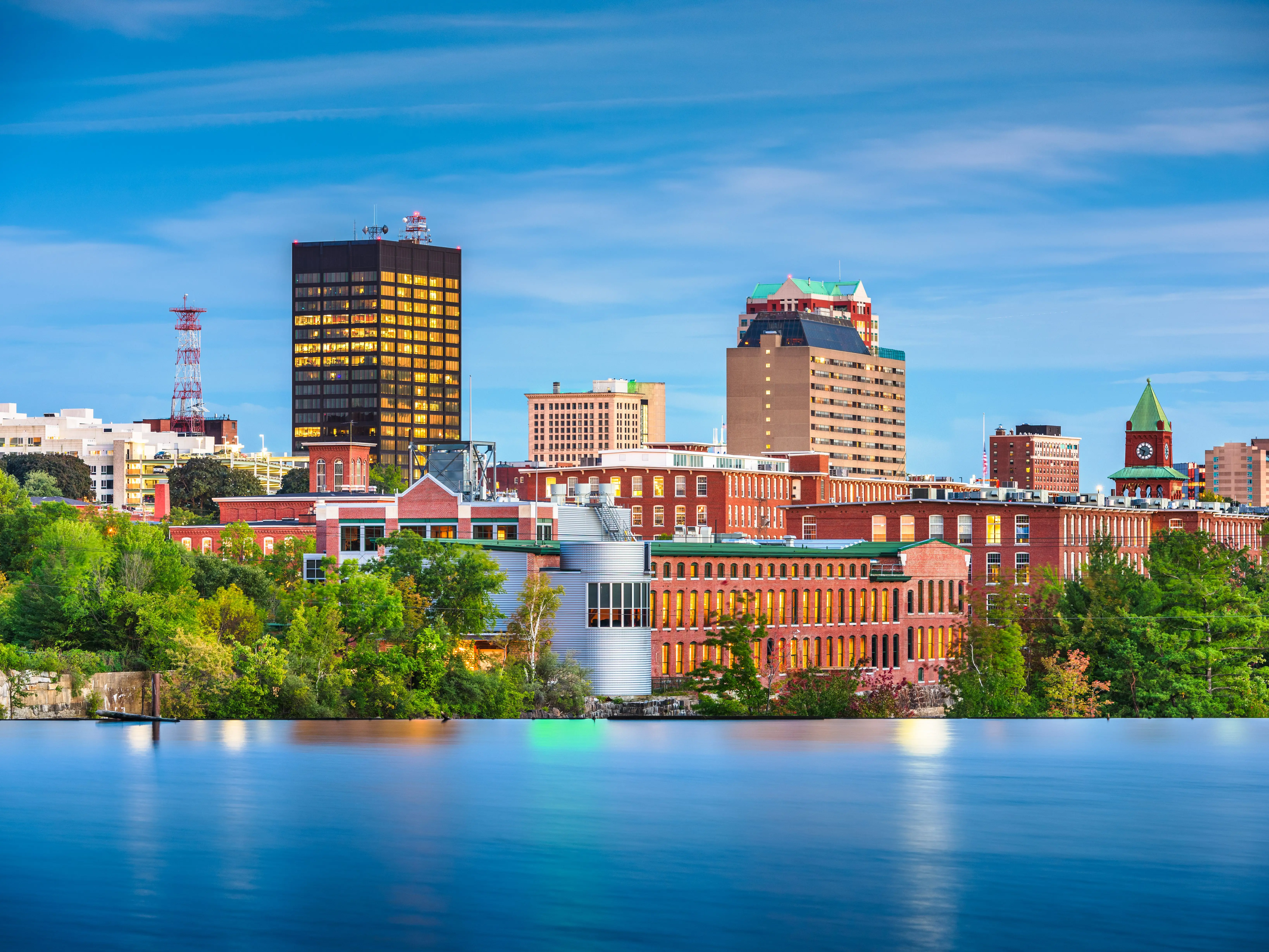 Manchester, New Hampshire, USA Skyline on the Merrimack River at dusk.