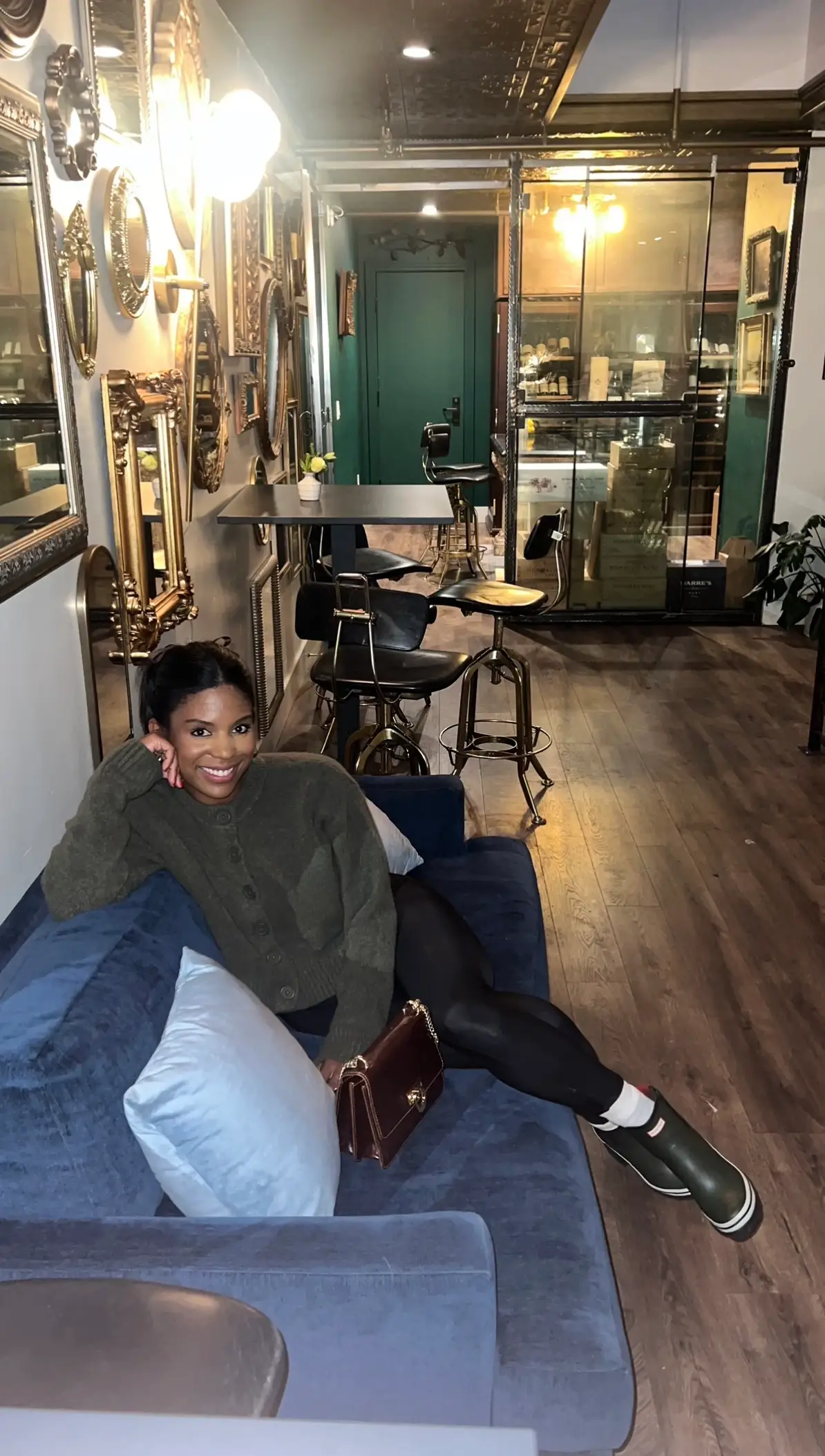 A woman posing on a couch.
