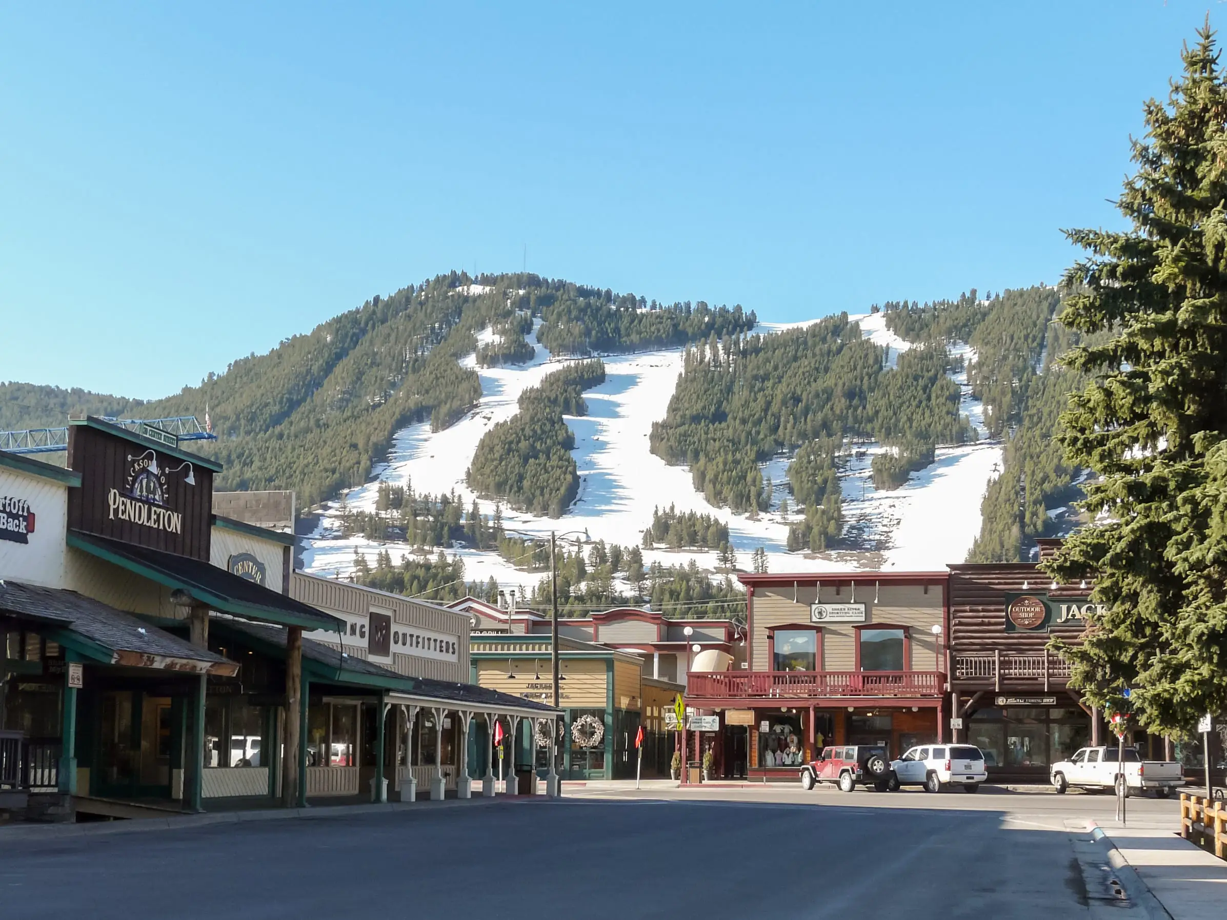 Jackson Hole, WY, USA - May 13, 2008: Ski slopes in Jackson Hole with panorama of vintage houses.