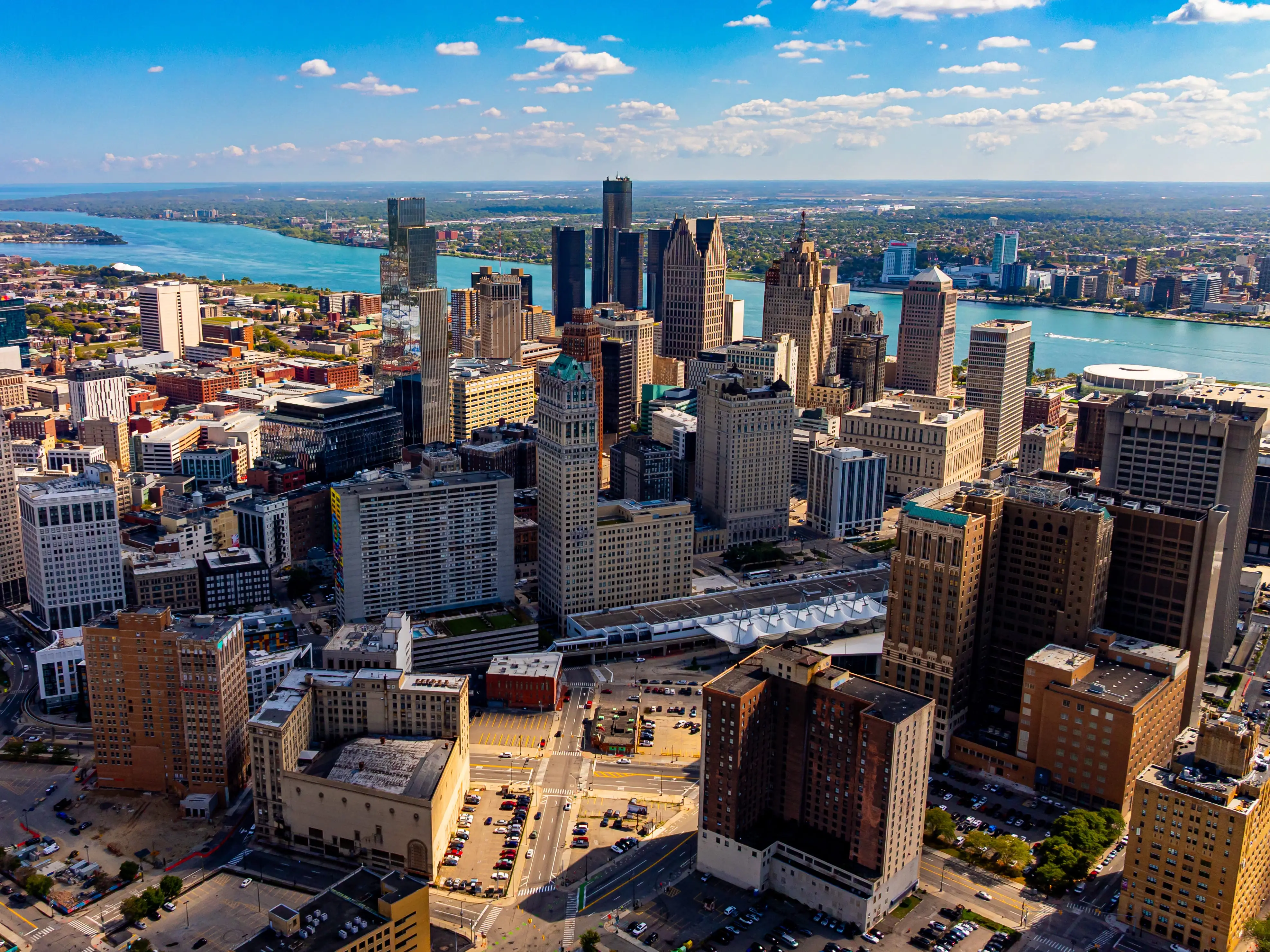 Downtown Detroit skyline and Detroit River. Drone aerial photo of downtown Detroit, Michigan with skyscrapers and the Detroit River on a sunny day.