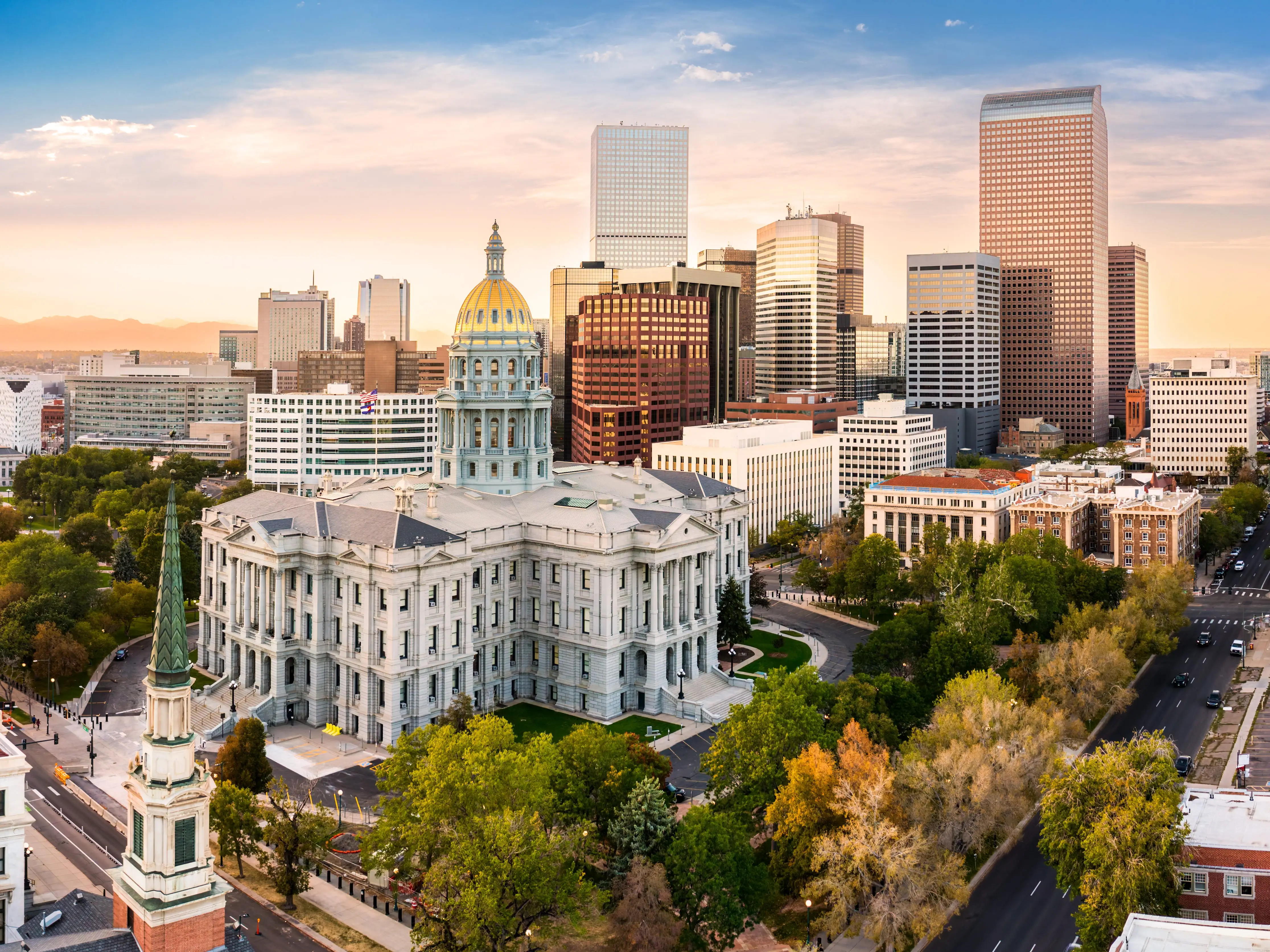 Aerial view of Colorado Capitol and Denver, Colorado skyline at sunset. Denver is a consolidated city and county, the capital, and most populous city of the U.S. state of Colorado