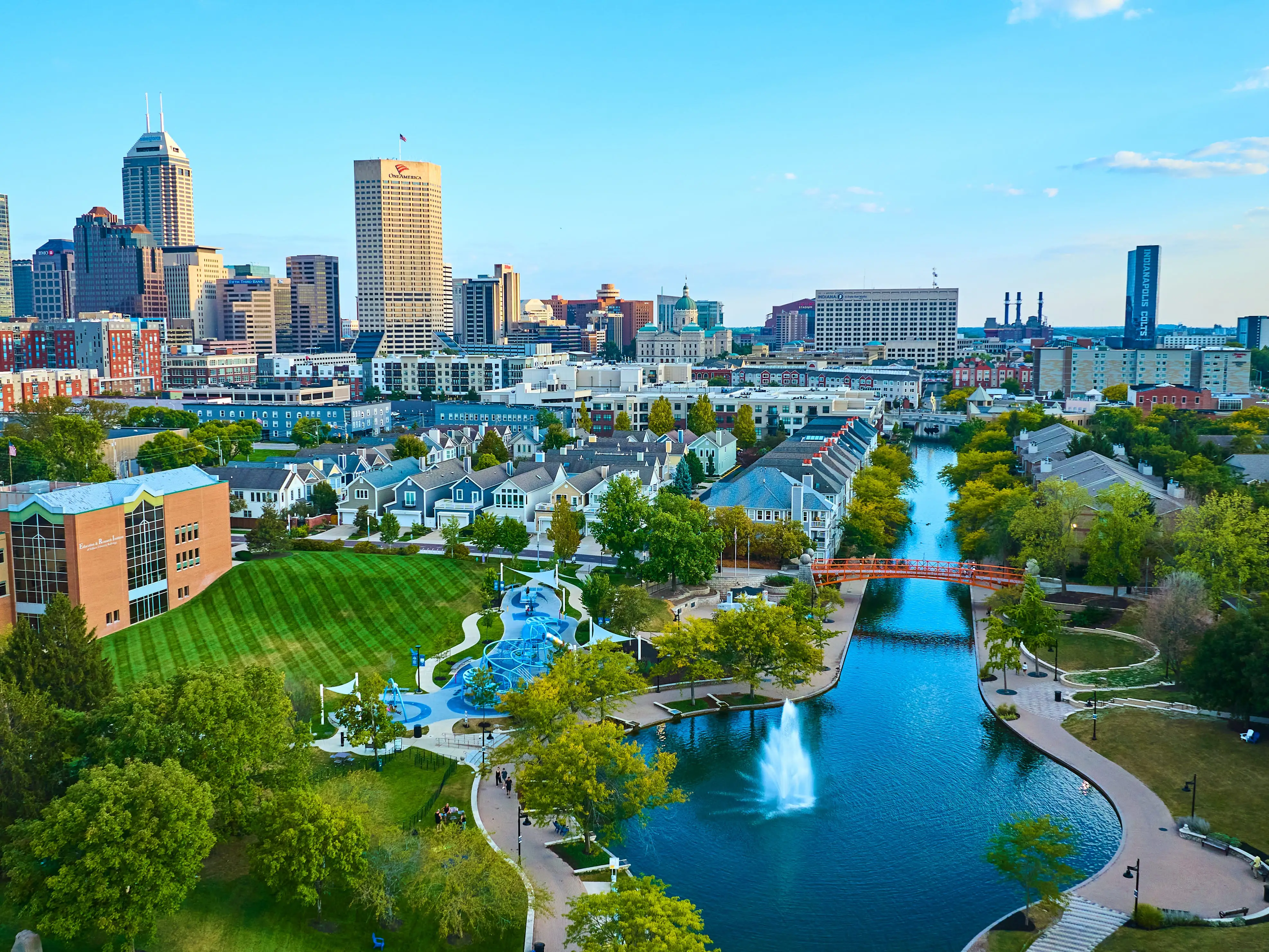 Aerial View of Vibrant Indianapolis Cityscape with Serene Park and Waterway at Golden Hour