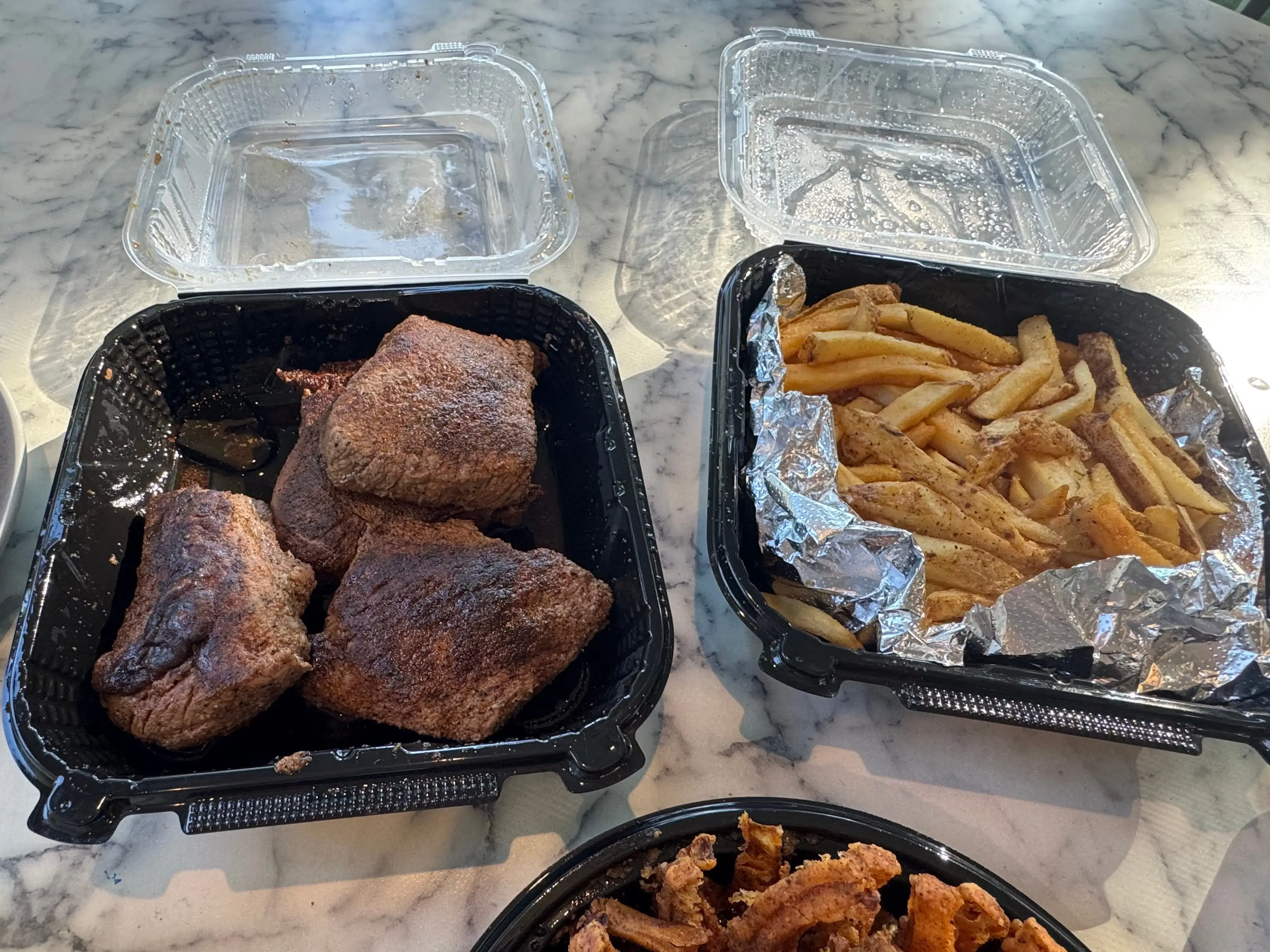 Steak, fries in plastic to-go containers